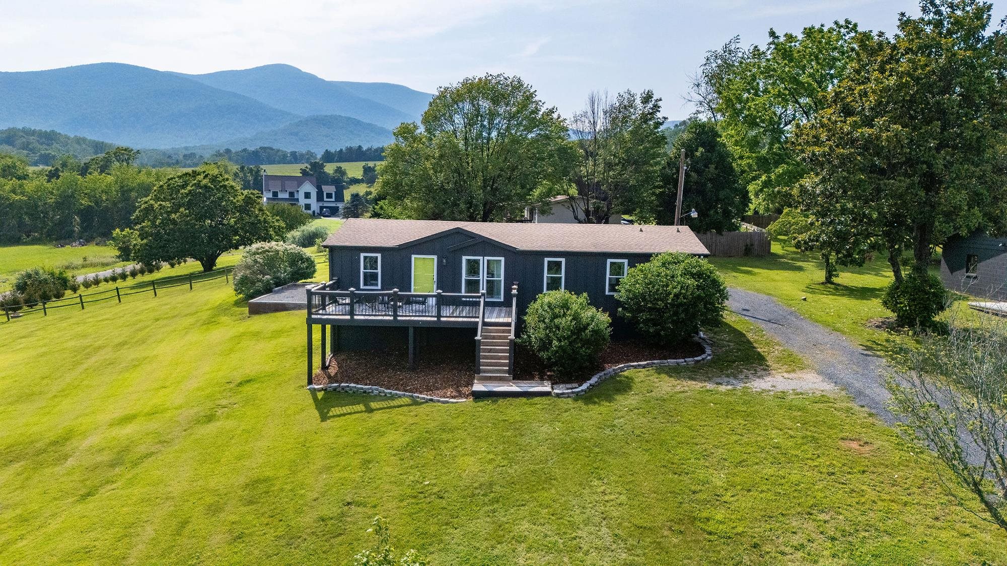 Enjoy stunning mountain views from this fully updated home on a large lot in the heart of Nelson County’s popular 151 corridor. Featuring an open floor plan, vaulted ceilings, and a spacious primary suite, this property is both stylish and functional. Currently a top-rated short-term rental earning ~$56K/year, it’s offered fully furnished for a true turn-key opportunity. Upgrades include a newer roof, HVAC, appliances, and furnishings. Septic and well recently serviced--ready for a quick closing! Minutes from Virginia’s top wineries, breweries, and hiking trails--this is your chance to own a beautiful home in one of Virginia’s most desirable destinations.