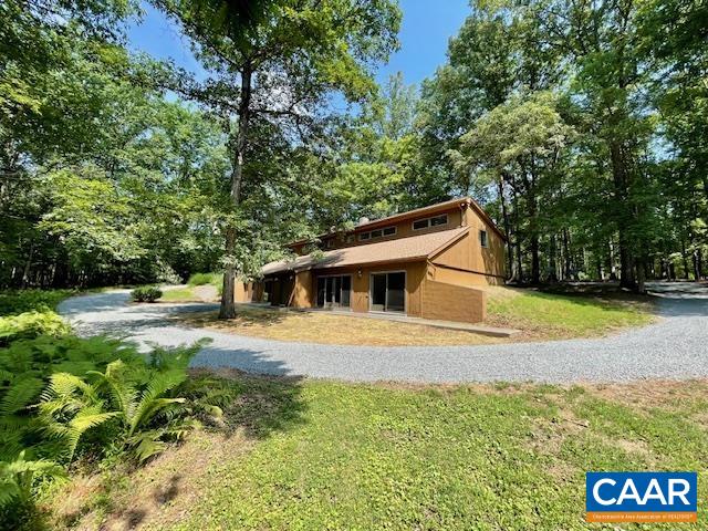 Live comfortably, earn income, work from home! Tucked away on just over 4 private acres in Albemarle, this unique contemporary duplex offers flexibility, function, and incredible value. Live in one side and rent out the other, two living spaces offers a great opportunity for extended family or rental income—the layout invites endless possibilities. The main living space features an open floorplan with an eat-in kitchen, a main-level bedroom and huge walk-in closet. Upstairs, you'll find a flexible loft area, an additional bedroom and bath with skylights, and convenient second-floor laundry. Sliding doors open to patio with wooded views and are accessible from living room and main floor bedroom. Recent upgrades includes a roof (ess than 10 years), brand new mini-splits, water treatment system, fresh interior paint, and new flooring on main level. With TONS of parking and privacy galore, this property blends contemporary design with versatile living under 10 miles to Hollymead Town Center, NGIC and area amenities.