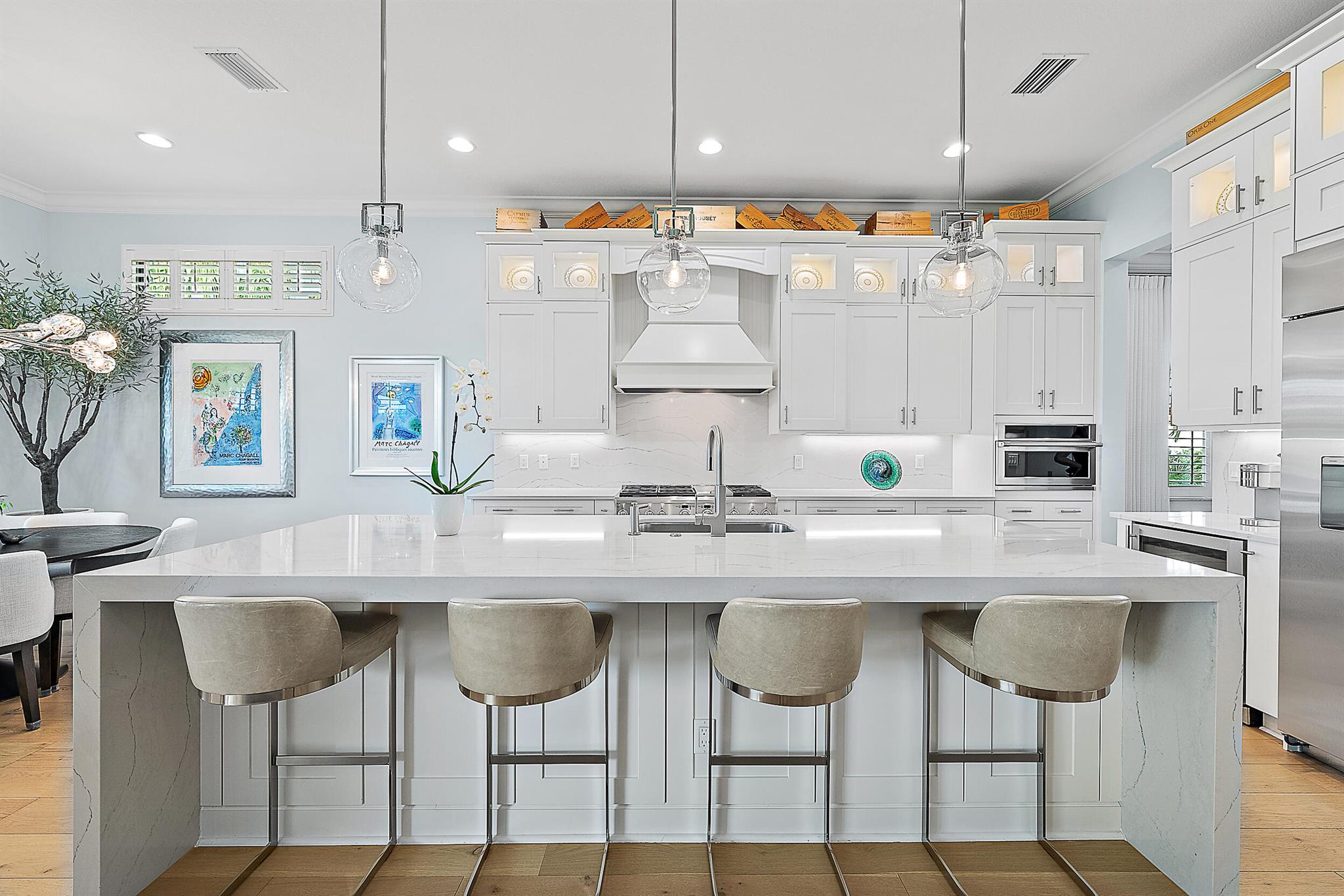 Perfectly situated in the center of Artistry, this home offers a peaceful water view and desirable southern exposure, filling the interior with natural light throughout the day. With an easement between you and the next-door neighbor, you'll enjoy a greater sense of privacy and space, rarely found in this community. Inside, tasteful upgrades and designer finishes create a polished yet comfortable atmosphere. White oak flooring, quartz surfaces, beautiful crown molding, and upscale fixtures are featured throughout. A versatile front room sets the stage for entertaining or formal gatherings, while the chef's kitchen delivers top-tier performance with GE Monogram appliances, a 6-burner gas range with griddle, three ovens, an oversized waterfall island, wine cooler, and upgraded cabinetry.

The spacious primary suite overlooks the water and includes multiple walk-in closets. The en-suite bath features floor-to-ceiling tile, creating a spa-like retreat with a clean, modern look.

Upstairs, you'll find well-appointed guest suites and a separate living area ideal for extended family, visiting guests, or a private retreat for kids or teens.

Located in the gated community of Artistry Palm Beach, residents enjoy a modern clubhouse, resort-style pool, state-of-the-art fitness center, playground, and scenic walking trails. All just minutes from A-rated schools, world-class golf, beaches, and fine dining in Palm Beach Gardens.