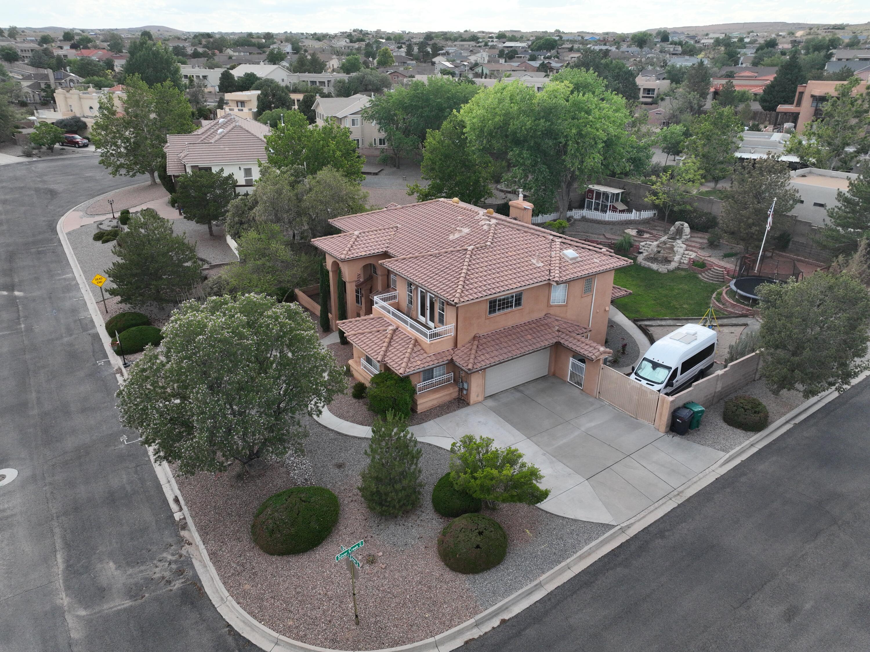 Welcome to this 5 bedroom, 3 bath home located on a quiet cul-de-sac in Rivers Edge right across the street from the Bosque and miles of walking trails. Enjoy the bright and open kitchen with a gas stove, granite countertops, and double pantry. The spacious living room is great for hosting and enjoying family gatherings. Primary suite has Sandia views and a jetted tub plus a walk-in shower and huge closet. Fully landscaped and private backyard with a waterfall, mature trees, large lawn, fenced garden, and chicken coop. The extra large insulated 2 car garage has an additional bay for a workshop. Includes a 50 amp outlet for RV and back yard vehicle access. 1 large bedroom and bathroom are downstairs for added flexibility. Plenty of room for family, working from home, and enjoying nature.