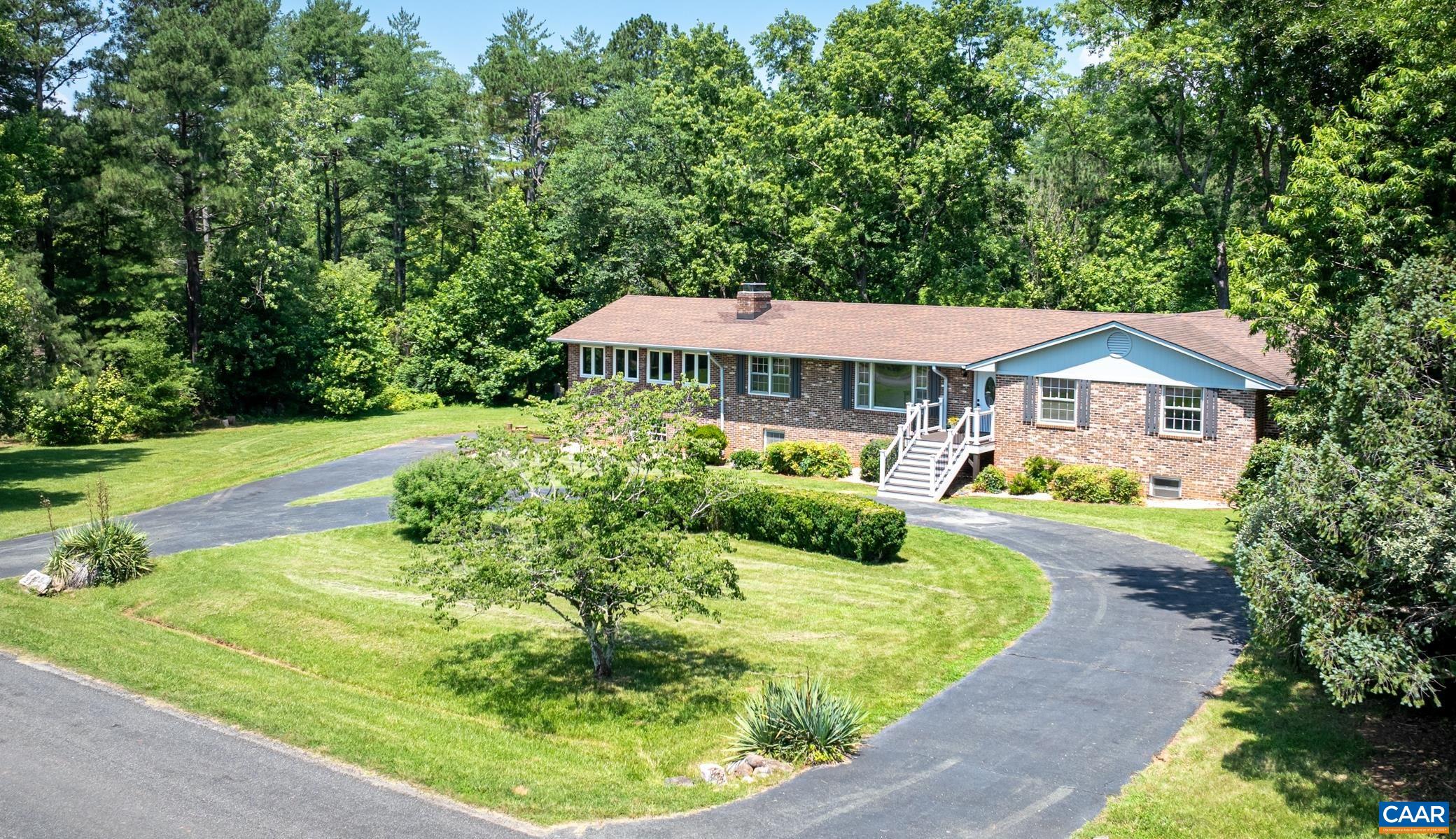 OPEN SUN, 8/3, 1:00-3:00! NEW PRICE! Open your next chapter in this MUST SEE brick home which has it all! Space for everyone with 5 bedrooms; main level living; 2 beautiful acres; wonderful privacy; and super convenient location, less than 15 min. from Charlottesville. An extraordinary value! Bathed in natural light and ready for your personal touches. Much of the main level has been freshly painted and offers a living room, study/den, spacious eat-in kitchen, gorgeous family room with woodstove and its own brand new HVAC system plus primary suite with adjoining home office and 4 additional bedrooms. The bright and cheerful terrace level features a 6th bedroom with en suite bath, rec room, 2nd home office and awesome family room with wood stove. Absolutely ideal for multi generation living with plenty of room for a kitchenette, plus separate entrance and covered patio. Newly stained decking in rear is a perfect spot to entertain, unwind and take in the sights and sounds of nature. Neighborhood access to the Rivanna Reservoir via lovely woodland path. Minutes from schools, shopping, dining and restaurants. Short drive to Ivy Creek Natural Area and Chris Green Lake plus hiking/biking trails, swimming holes, wineries and breweries.