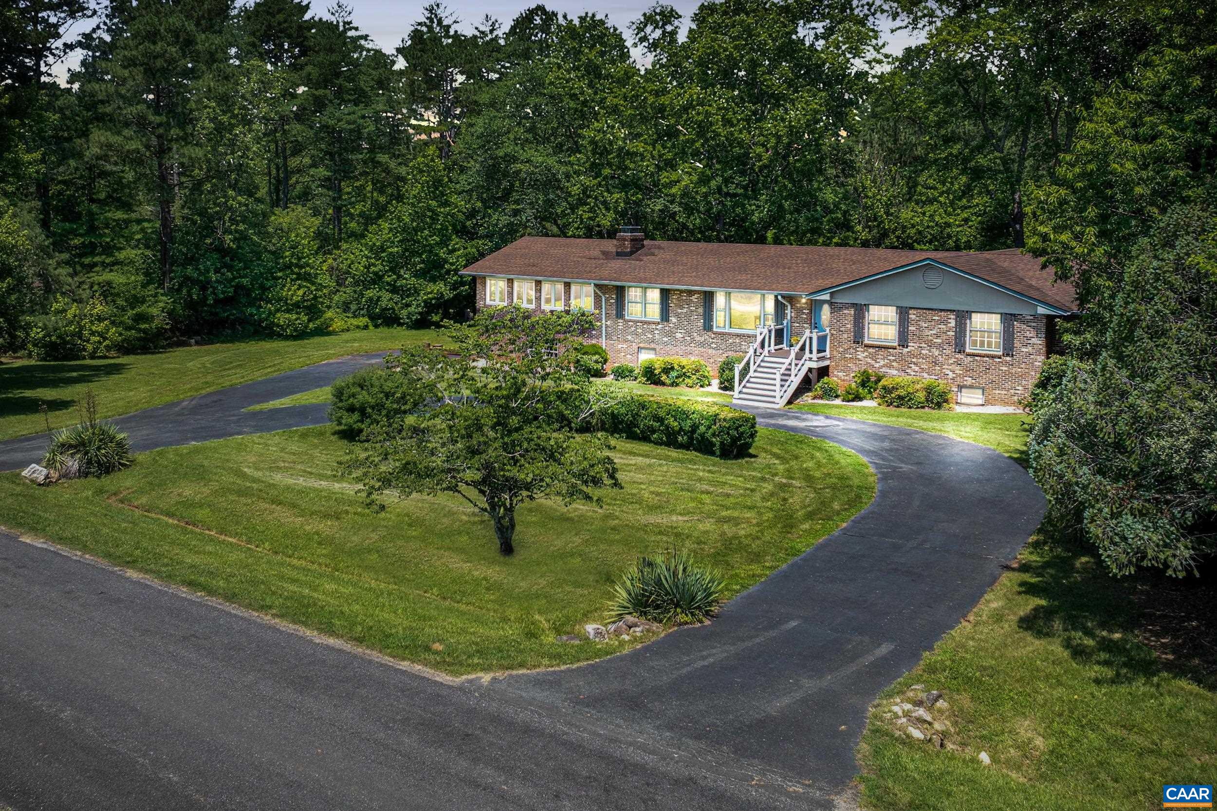 MOTIVATED SELLERS / OFFERS WELCOME! Open your next chapter in this must-see brick home which has it all! Space for everyone with 5 bedrooms; main level living; 2 beautiful acres; wonderful privacy; and super convenient location, less than 15 minutes from Charlottesville. An extraordinary value! Bathed in natural light and ready for your personal touches. Much of the main level has been freshly painted and offers a living room, study/den, spacious eat-in kitchen, gorgeous family room with woodstove and its own brand new HVAC system plus primary suite with adjoining home office and 4 additional bedrooms. The bright and cheerful terrace level features a 2nd primary suite, rec room, 2nd home office and another awesome family room with wood stove. Absolutely ideal for multi generation living with plenty of room for a kitchenette, plus separate entrance and covered patio. Newly stained decking in rear is a perfect spot to entertain, unwind and take in the sights and sounds of nature. Neighborhood access to the Rivanna Reservoir via lovely woodland path. Minutes from schools, shopping, dining and restaurants. Short drive to Ivy Creek Natural Area and Chris Green Lake plus hiking/biking trails, swimming holes, wineries and breweries.