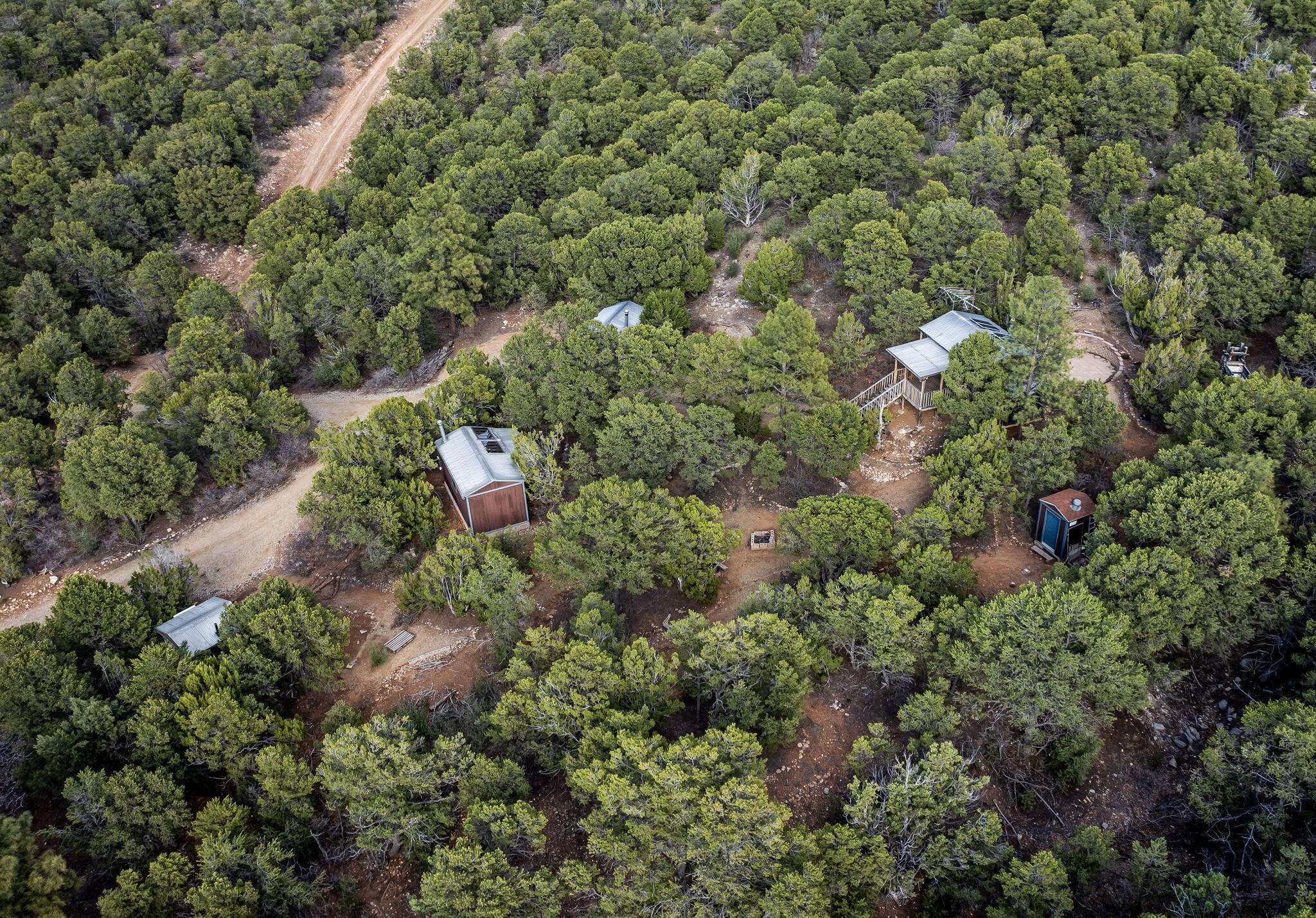 OWNER FINANCING OFFERED The on-site cabins have been upgraded with new televisions, beds, and couches. Furthermore, each unit has been fully furnished with decorative elements, kitchenware (including pots, pans, and cups), fresh bedding, and towels. All units are equipped with functional wood-burning stoves, with the largest unit also featuring a gas stove. These accommodations are fully prepared for guest occupancy!