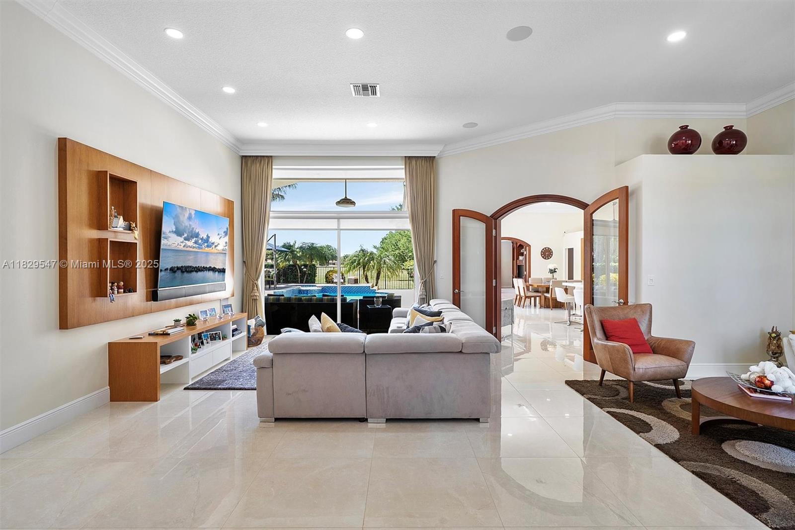 Step into a world of refined luxury and seclusion with breathtaking views of the elite golf course. This exquisitely updated home boasts a grand main suite with vast closets, two stylish ensuite bedrooms with bespoke closets, and a gourmet kitchen with cutting-edge design. Host unforgettable gatherings in the sophisticated dining area and dual living spaces. Unwind in the sleek family room with stunning vistas, or retreat to the spacious office. Upstairs, find two private bedrooms with a shared bath. Outside, a lavish pool oasis with spa, shower, travertine details, and a wooden deck overlooks the verdant fairways. Savor the pinnacle of Weston Hills living—your dream home awaits!