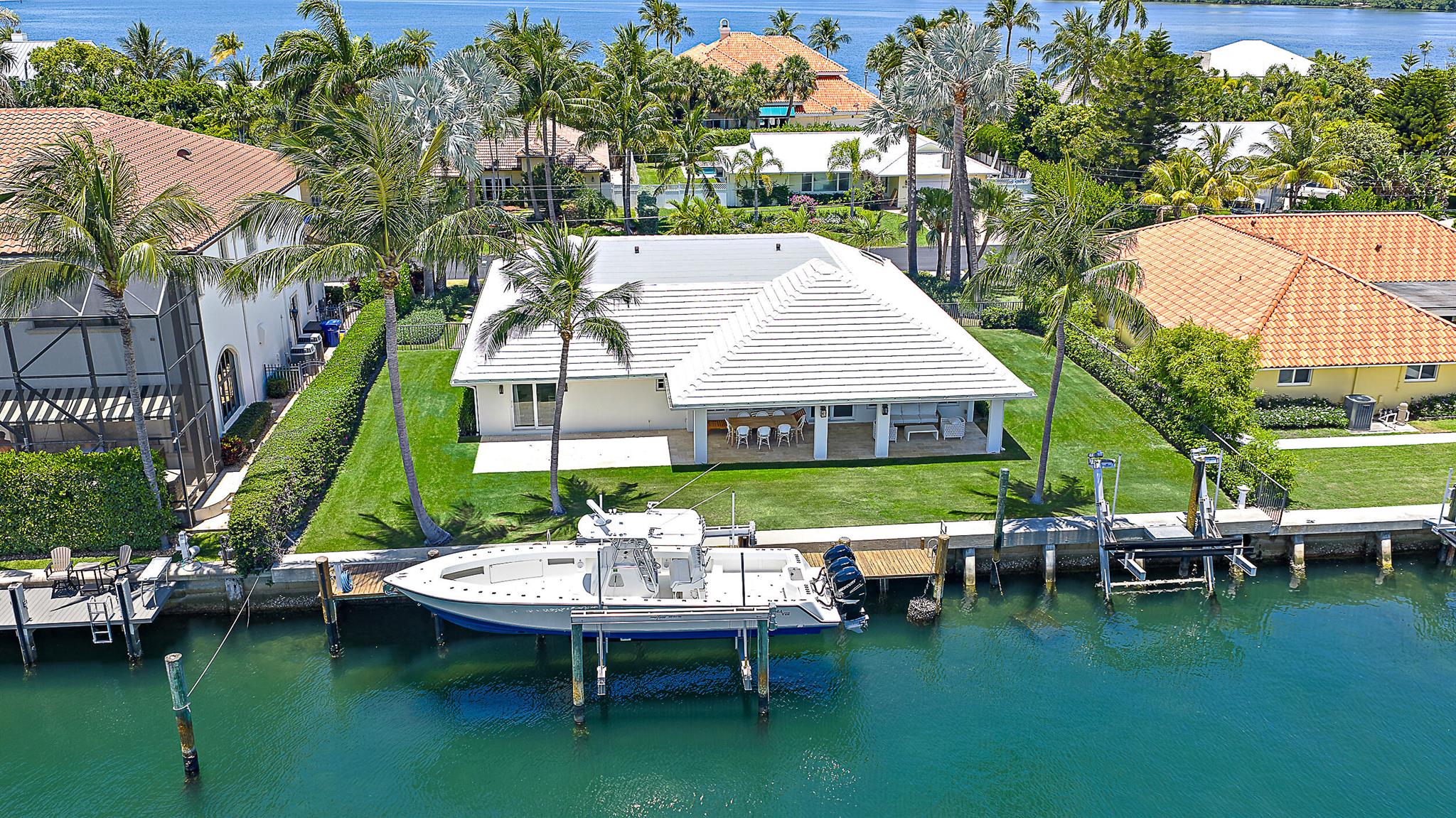 Just minutes from the Palm Beach Inlet this Palm Beach Isles home offers 100' of deepwater frontage, a 65' dock with two boat lifts: 24,000lbs & 10,000lbs. This home offers an updated kitchen with stainless appliances, updated bathrooms, new roof and impact windows 2023 and a 16KW Generac generator.
