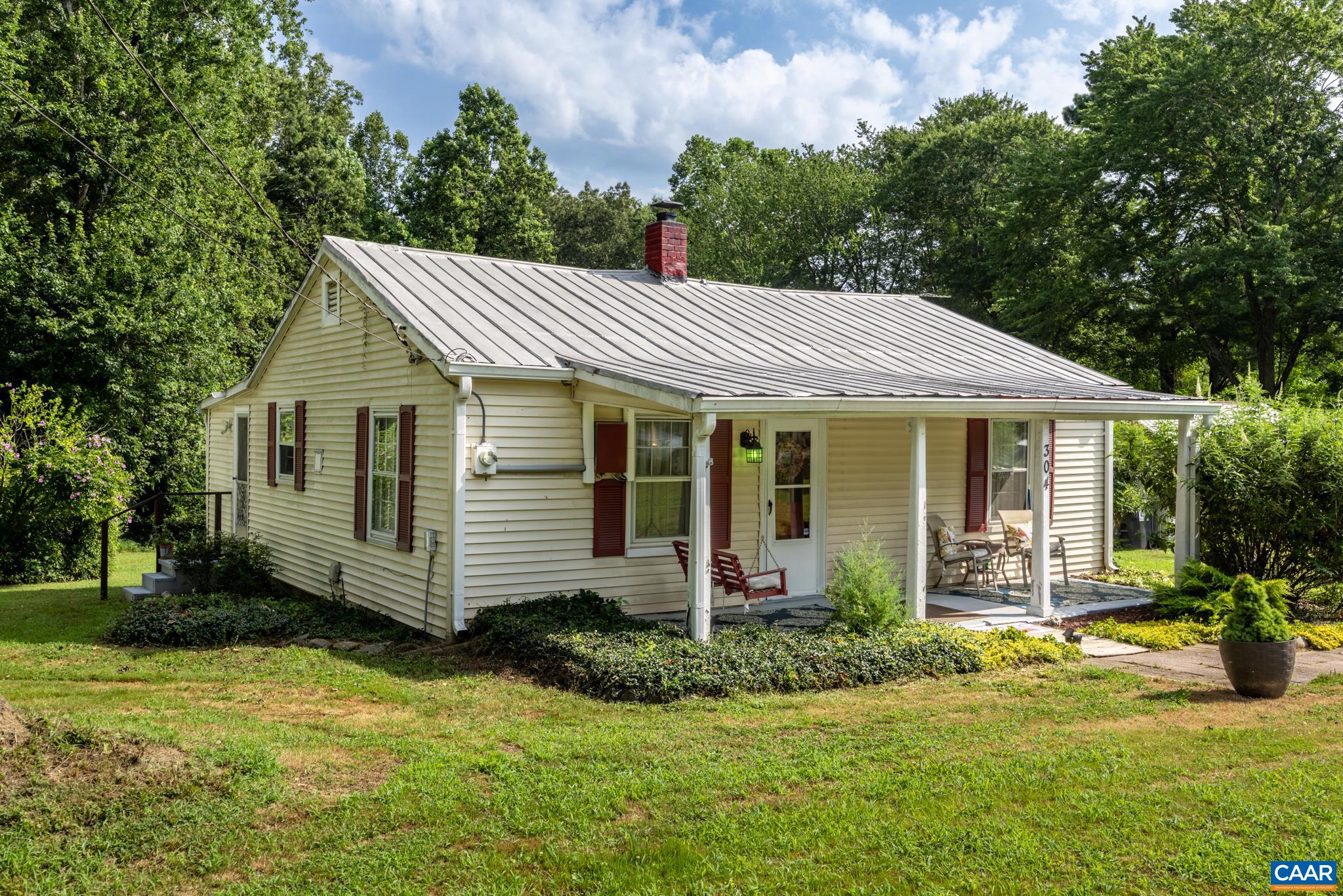 Adorable home only 15 minutes away from Pantops Mountain!  Serene ONE LEVEL LIVING on almost 2 acres of land w/ a multitude of outbuildings.  Upon entry is a cozy FORMAL LIVING RM that leads into the EAT-IN Kitchen.  The FAMILY RM is gloriously spacious for TV, games, and recreation.  The yard has many flowering trees/bushes with ample open space for outdoor activities while maintaining a mature forest along its perimeter for privacy and exploring.  The large laundry room also serves as an area for storage.  Minutes from the Albemarle County line and close to retail/grocery shopping, restaurants, Martha Jefferson Hospital, and the Historic Downtown Mall!