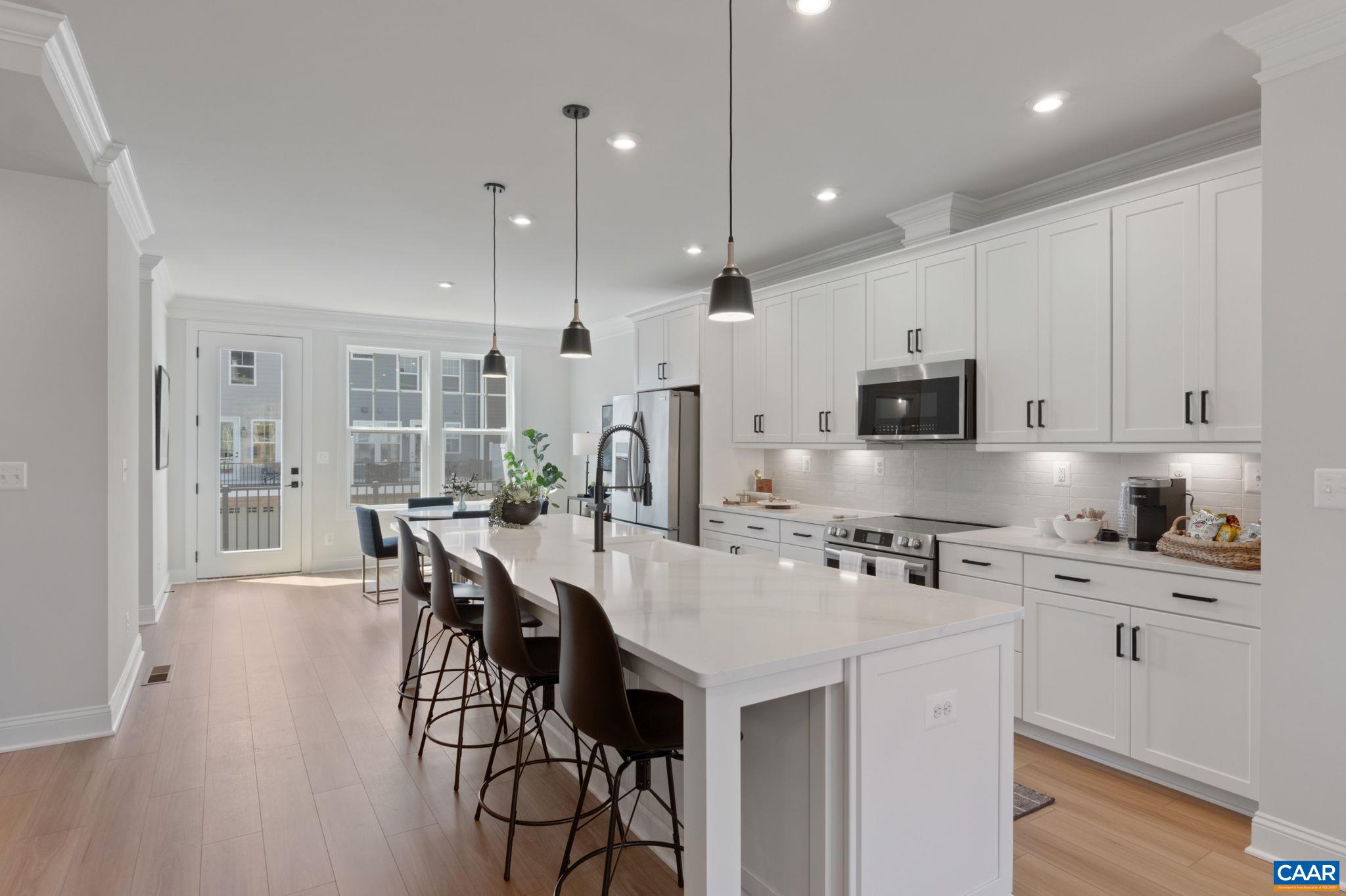Final end unit opportunity at Dunlora Park, now under construction with an estimated August 2025 move-in. This Dogwood townhome offers an open layout that feels spacious and inviting from the moment you step inside. The main level flows from the living area to the kitchen and dining space, with a walk-in pantry, half bath, and low-maintenance deck just off the back—great for relaxed evenings or casual get-togethers. Upstairs, the primary suite includes a private bath, while two additional bedrooms share a full hall bath. The laundry area is also on this level for added convenience. A finished rec room sits just off the attached 2-car garage. Photos show a similar home and may include upgrades.