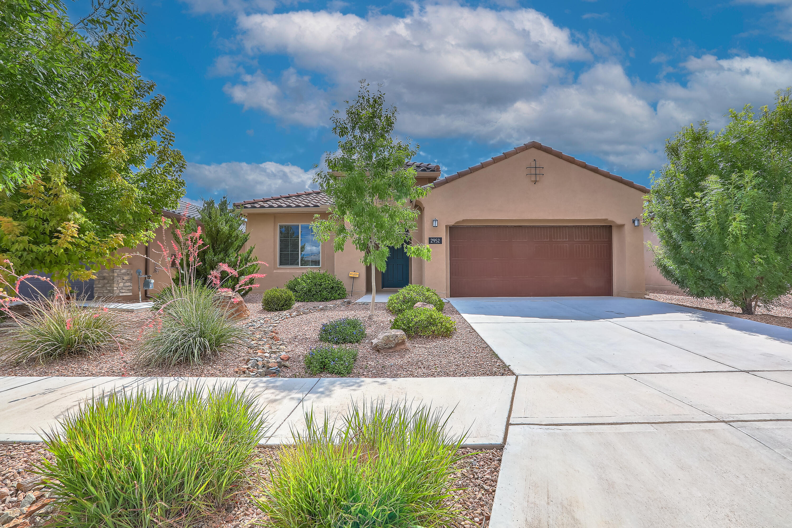 NO PID!!! The seller will contribute up to $5,000 towards buyer's closing costs with an acceptable offer. Experience this absolutely gorgeous Pulte home in a beautiful gated community. Move-in ready! Enjoy newer appliances, gorgeous tile and wood-look laminate, refrigerated air, tank-less hot water heater, and so much more! The chef's kitchen has luxurious granite counters, beautiful wood cabinets, and tile backsplash that is open to the living area. The owner's suite has a large walk-in closet. The covered patio extends to the fully landscaped backyard with a fountain and fire pit to enjoy the amazing New Mexico weather.  Park in the large, 2-car garage. The close-by community center has 2 pools, a gym, a yoga studio, yummy cafe, and a huge park in addition to the miles of nature trails.