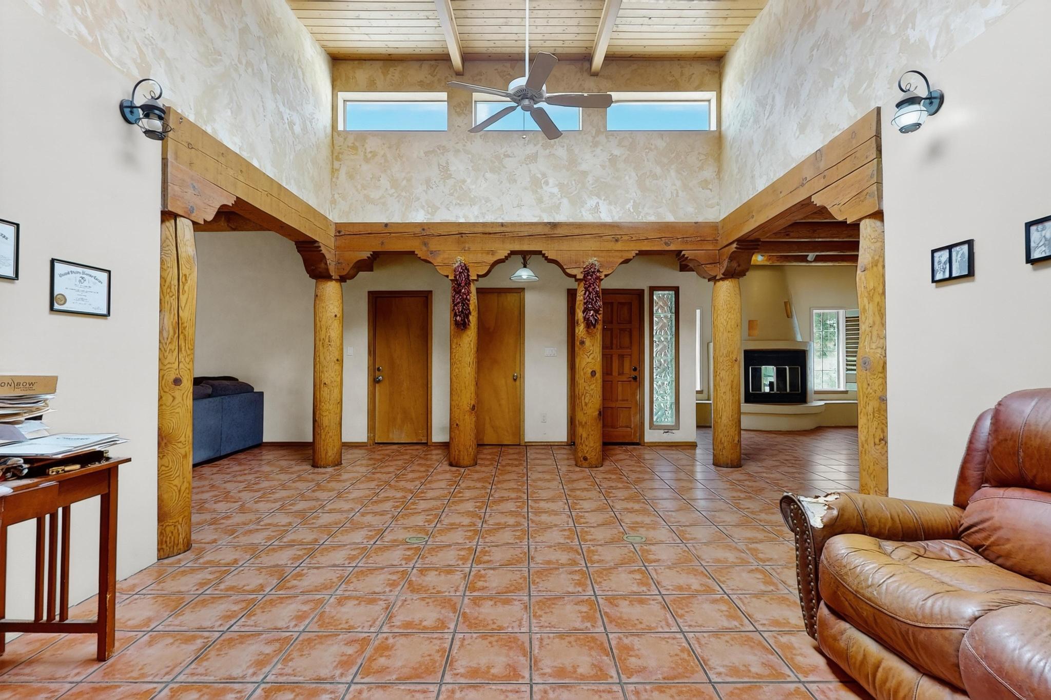 Priced reduced $60k! Charming 3BR, 2BA, 2CG home in the desirable Heritage East subdivision! La Cueva School District! Features gorgeous Saltillo tile, 3 cozy fireplaces, classic vigas, plantation shutters, and skylights that flood the home with natural light. The kitchen comes fully equipped--all appliances convey. Enjoy mirrored closets, ceiling fans, tile-surround shower, and double sinks. Unique Venetian-painted wall pairs beautifully with the tongue & groove ceiling. Relax by the window seat and take in the peaceful ambiance. This home blends Southwestern charm with everyday comfort--don't miss out, this home will sell fast!