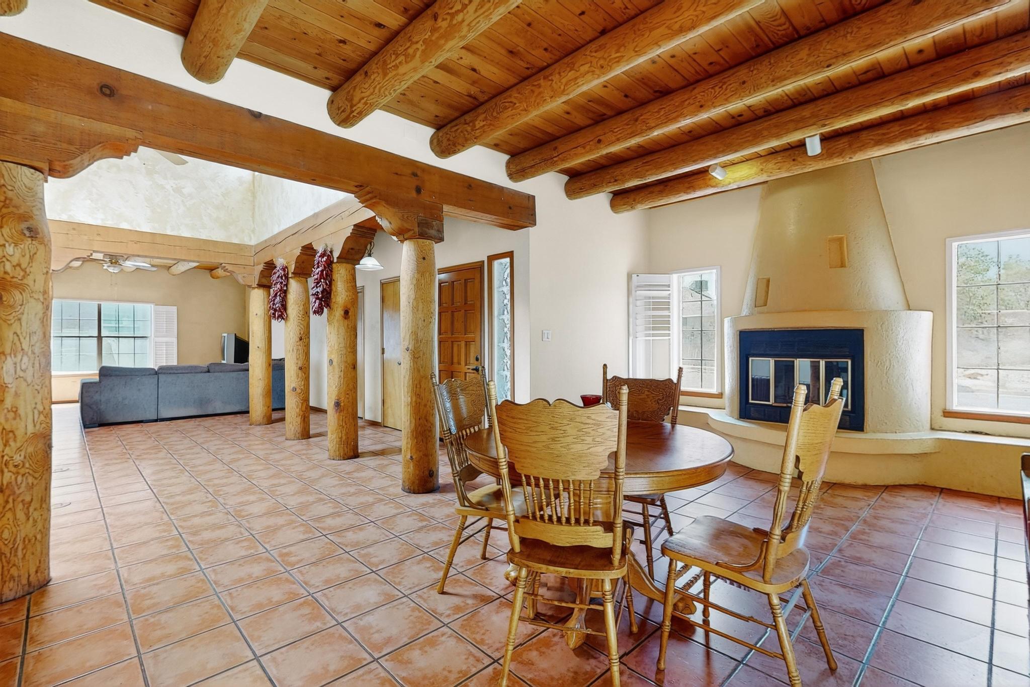 Charming 3BR, 2BA, 2CG home in the desirable Heritage East subdivision! La Cueva School District! Features gorgeous Saltillo tile, 3 cozy fireplaces, classic vigas, plantation shutters, and skylights that flood the home with natural light. The kitchen comes fully equipped--all appliances convey. Enjoy mirrored closets, ceiling fans, tile-surround shower, and double sinks. Unique Venetian-painted wall pairs beautifully with the tongue & groove ceiling. Relax by the window seat and take in the peaceful ambiance. This home blends Southwestern charm with everyday comfort--don't miss out, this home will sell fast!