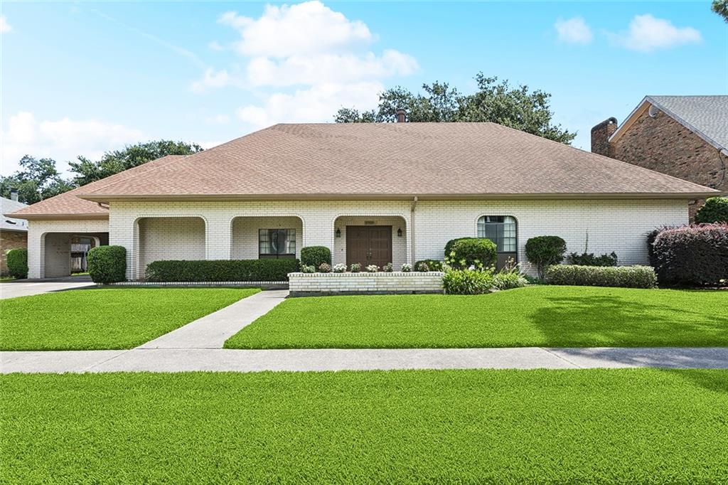BROKER TOUR TUESDAY 7/22/25 FROM 11-1PM!  This family home was built in 1973, first time on the market.  Lot is 100x120 steps from the lakefront!  5 bedrooms, 3.5 baths, plus office, game room, dark room, sun room and more! Solid built with entertaining in mind, all open from the kitchen, den, dining and living areas.  Den has a wood burning fireplace, recessed lights and built in shelving.  Primary is large with his and her vanities and closets.  All bedrooms are downstairs with walk in or double closets.  Upstairs has a large game room, half bath, dark room, sun room and office.  Attached carport with storage area.  Rear yard landscaped with gorgeous oak tree and privacy fence.  Bring your inner decorator vibe and make this home your own sanctuary!  It truly is a one of a kind property!