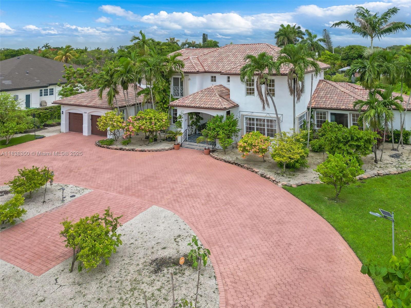 Beautifully maintained home on a corner lot (over 1 Acre). Home features 6 Bedrooms and 5 full baths, office/library, exercise room, enclosed patio with air conditioning, 3 central A/C units and many mature fruit trees (mango, papaya, guava, passion fruit and many more).

Land provides more than ample space to add additional structure if desired.