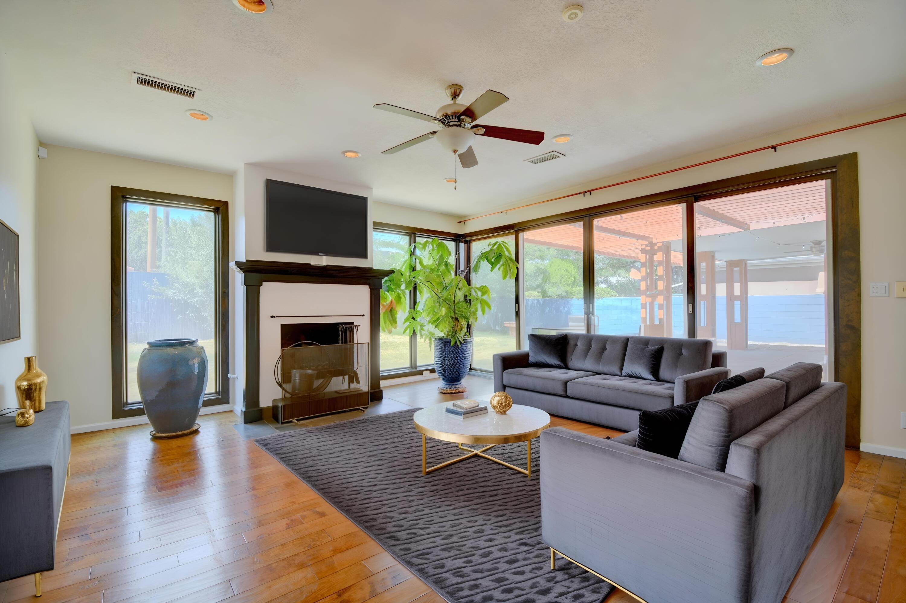 PRICE DROP! On the lovely Brick home in the Albuquerque Country Club. Pitched Roof, Refrigerated Air, Remodeled with a large Primary Room, and large Primary Bath, Steam shower and jetted tub. New carpet installed in 7/2025 in bedrooms, Lovely engineered hard wood in the living spaces.  Bright and cheerful kitchen, new refrigerator 7/15, lots of windows and light throughout the home.  Two large fireplaces, one in the dining room. Large back yard. Plus plenty of room to add your own style.  Come see it today