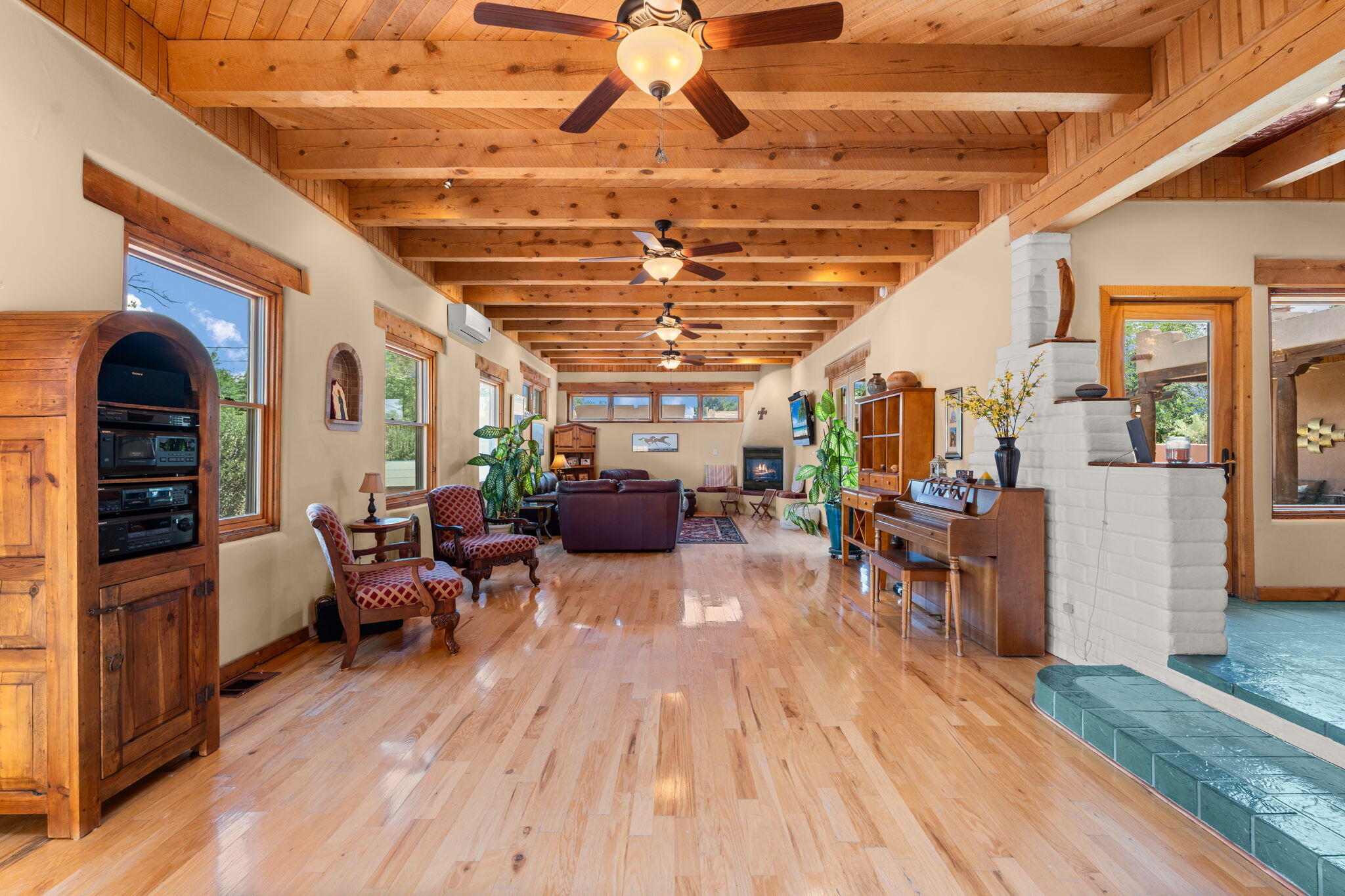 The SW charm of this 4BD/4BA exquisite custom home in the heart of Los Ranchos is unrivaled. Featuring 4 beautiful fireplaces, the more than 4,000 sq ft of living space provides unlimited versatility for in-law quarters, office space, etc.  An interior wet bar & numerous doors leading out to the courtyard & outdoor kitchen make this home a true dream for entertaining. The formal dining room is conveniently serviced by the adjacent kitchen featuring a perfectly located pass-thru. The massive primary BR/BA is 943sq/ft of resort-like luxury. The main family room is giant at 735 sq/ft. No expense was spared in appointing this stunningly spacious home with beautiful hardwood floors, arched doors/doorways and stunning architectural wood ceilings. Just minutes from fine dining and shopping.