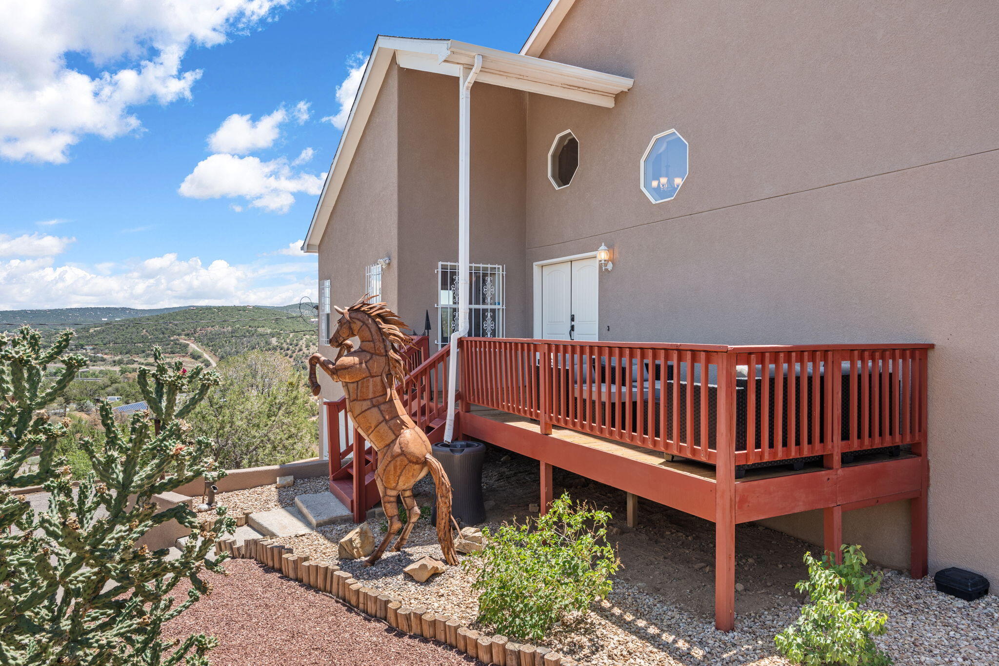 Perched on a hilltop with panoramic Sandia Mountain views, this stunning retreat blends luxury with nature. Floor-to-ceiling windows, a cozy fireplace, and an updated kitchen offer comfort and style. Enjoy sunrises and sunsets from the wrap-around deck or unwind in the private hot tub under the stars. Gated entry, a serene master suite with private balcony, and nearby trails make this home a rare find. Experience mountain living just minutes from the city--your oasis awaits!