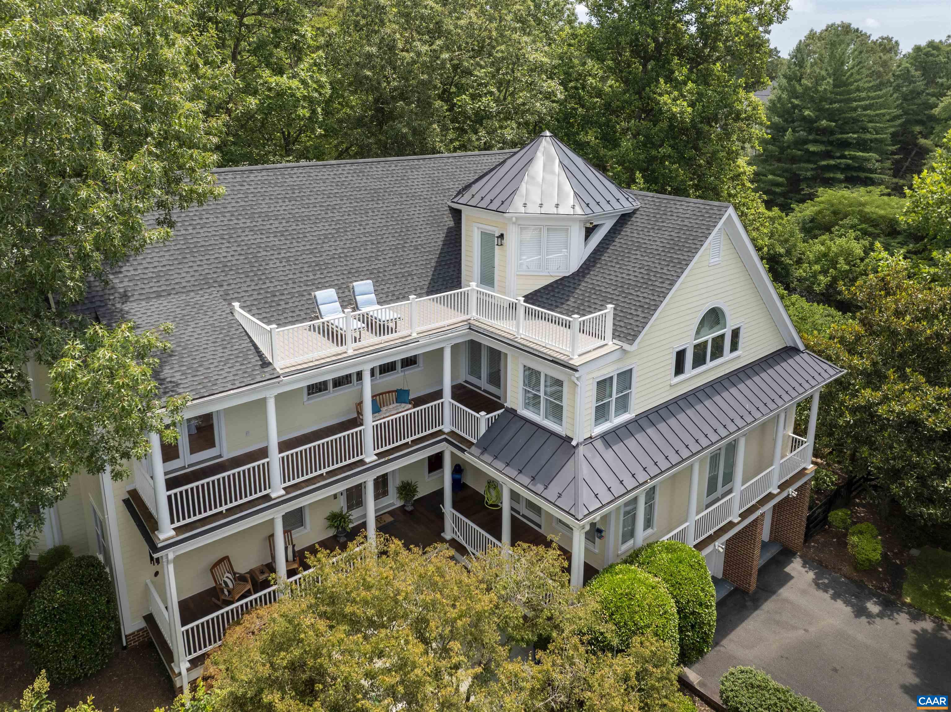 Set on a quiet cul-de-sac in Glenmore, this distinctive four-level home stands apart with its expansive mountain views, stylish updates, and exceptional outdoor living. Enjoy sunsets over Monticello from three levels of outdoor space—perfect for relaxing or entertaining. Thoughtful 2024 upgrades include a new roof with metal accents, updated second-level HVAC, refreshed upstairs hall bath, and a garage outlet ready for EV charging. The main level features generous gathering areas, a cozy library alcove, two fireplaces, and a well-appointed kitchen with cherry cabinetry, quartzite counters, Jenn-Air appliances, and a butler’s pantry. Upstairs you’ll find four bedrooms, including a spacious primary suite with a spa-like bath and access to one of the home’s view-filled decks. The top floor offers a light-filled sitting area and a private office with breathtaking vistas and its own secluded outdoor retreat. The terrace level adds a large rec room, bedroom, and full bath with walk-out access to a fenced yard. A rare blend of character and functionality—just a short golf cart ride to the Club at Glenmore. Current membership qualifies buyer for a 50% discounted initiation fee for club membership.