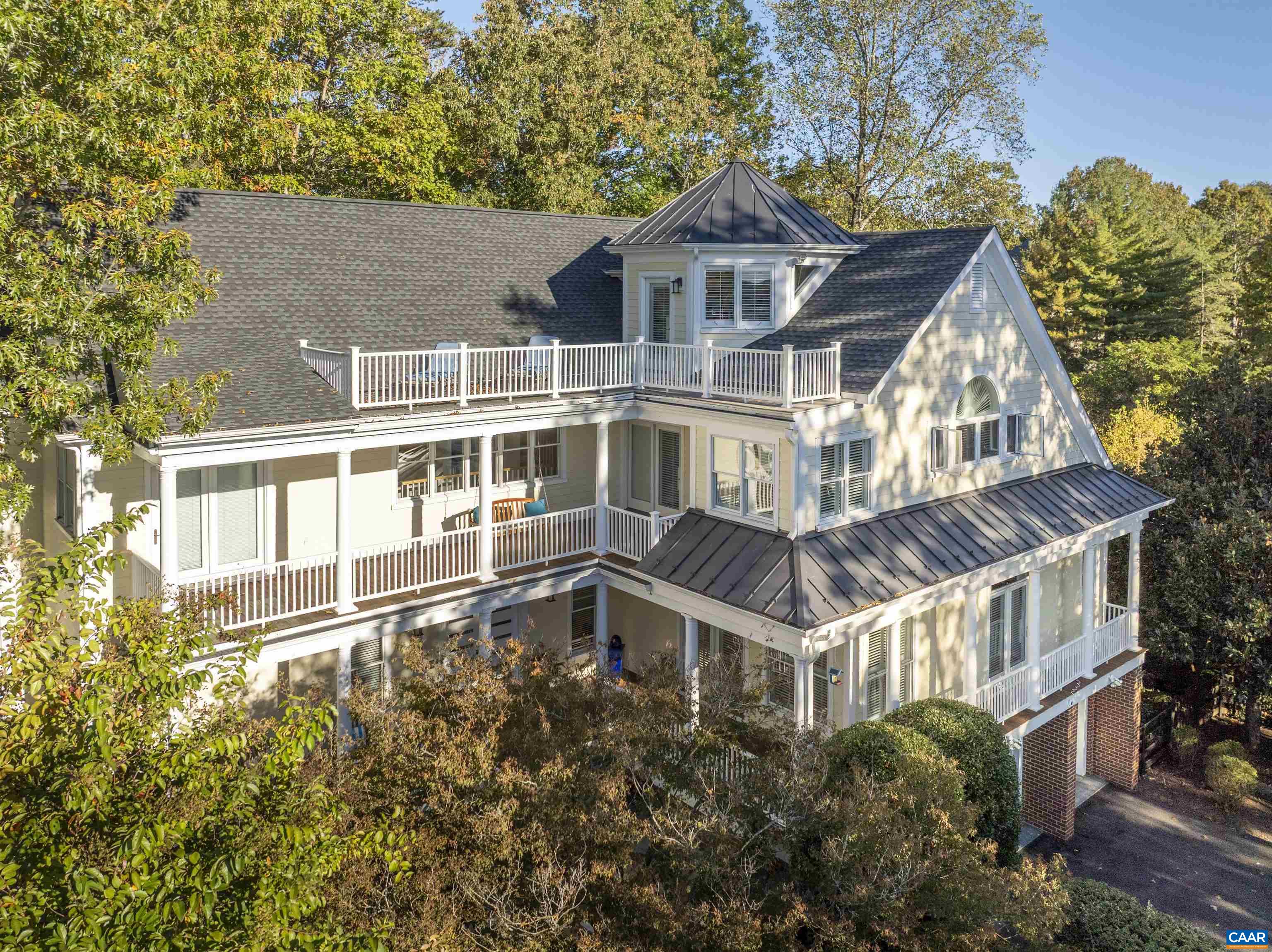 Set on a quiet cul-de-sac in Glenmore, this distinctive four-level home stands apart with its expansive mountain views, stylish updates, and exceptional outdoor living. Enjoy sunsets over Monticello from three levels of outdoor space—perfect for relaxing or entertaining. Thoughtful 2024 upgrades include a new roof with metal accents, updated second-level HVAC, refreshed upstairs hall bath, and a garage outlet ready for EV charging. The main level features generous gathering areas, a cozy library alcove, two fireplaces, and a well-appointed kitchen with cherry cabinetry, quartzite counters, Jenn-Air appliances, and a butler’s pantry. Upstairs you’ll find four bedrooms, including a spacious primary suite with a spa-like bath and access to one of the home’s view-filled decks. The top floor offers a light-filled sitting area and a private office with breathtaking vistas and its own secluded outdoor retreat. The terrace level adds a large rec room, bedroom, and full bath with walk-out access to a fenced yard. A rare blend of character and functionality—just a short golf cart ride to the Club at Glenmore. Current membership qualifies buyer for a 50% discounted initiation fee for club membership.