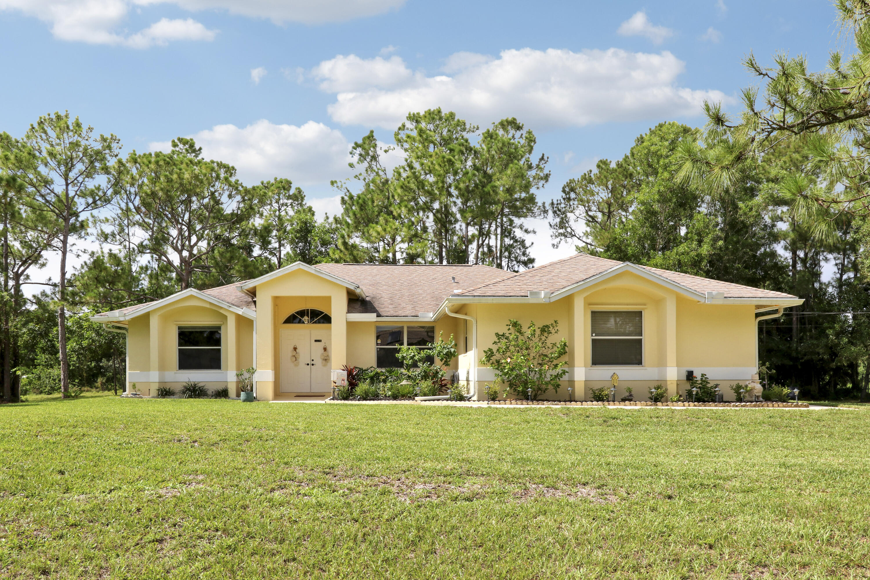 Welcome to 18854 48th Avenue N, Loxahatchee a charming residence nestled in the serene community of Loxahatchee, FL. This inviting property offers a rare opportunity to own a home on 1.29 acres with no HOA restrictions, providing ample space and freedom to create your ideal living environment. Spanning 1,615 square feet, this home features a thoughtful split-bedroom layout with three bedrooms and two bathrooms, ensuring privacy and comfort for all occupants. The spacious kitchen is a culinary enthusiast's dream, equipped with granite countertops and a convenient island that enhances both functionality and style. The primary suite serves as a tranquil retreat, offering a peaceful haven for relaxation. Many exotic fruit trees in the backyard-papaya, jack fruit & soursop & butterfly garden! With room for a pool, the expansive outdoor space presents endless possibilities for recreation and entertainment. Situated close to the renowned White Fences equestrian community, this property offers easy access to major highways, including the Turnpike and I-95, making commuting and travel a breeze. Whether you seek a quiet escape or a vibrant lifestyle, this location caters to diverse preferences. This property is for sale, presenting a unique opportunity to own a piece of Loxahatchee's serene landscape. Experience the blend of comfort, convenience, and natural beauty at 18854 48th Avenue N. Schedule a viewing and explore the potential of this exceptional home today.