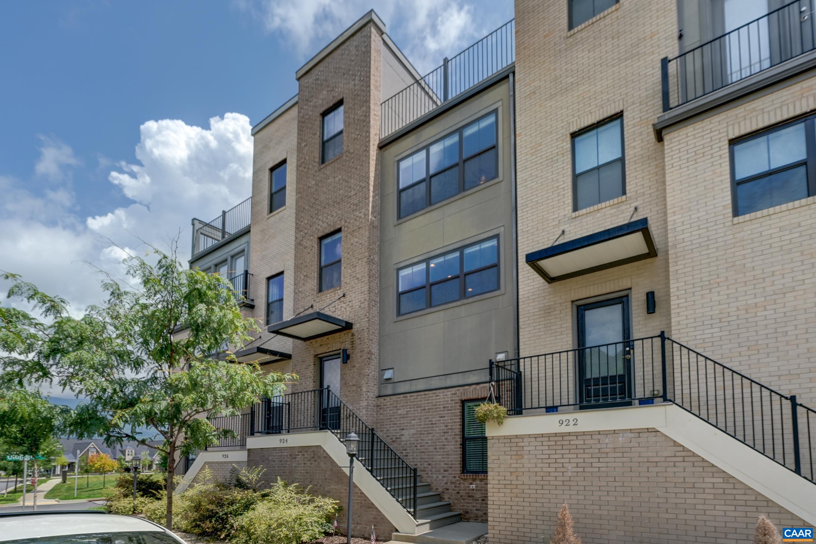 Discover an extraordinary Eco-Friendly living experience in Old Trail, where this four-story townhome combines modern design with mountain vistas walkable to the Town Center. The heart of the home is an open-concept living area with luxury vinyl plank flooring and a modern kitchen that boasts hardwood cabinetry, granite countertops and stainless appliances - perfect for both everyday living and entertaining. The home's thoughtful layout maximizes both comfort and functionality. The bedroom level showcases a generously sized owner's suite with a private bathroom with two sink areas and a sleek, frameless-glass shower. A second primary suite features an ensuite bathroom with tub/shower combo, and a full sized laundry room features a full-sized Maytag Washer and Dryer. The ground floor offers versatility with a third bedroom/home office with full bathroom, and mudroom. Perhaps the true gem of this property is the spectacular rooftop terrace—an urban oasis that will become your favorite retreat. Practicality meets luxury with a one-and-a-half-car rear-entry garage and a wide rear deck for al fresco dining. Don't miss out!