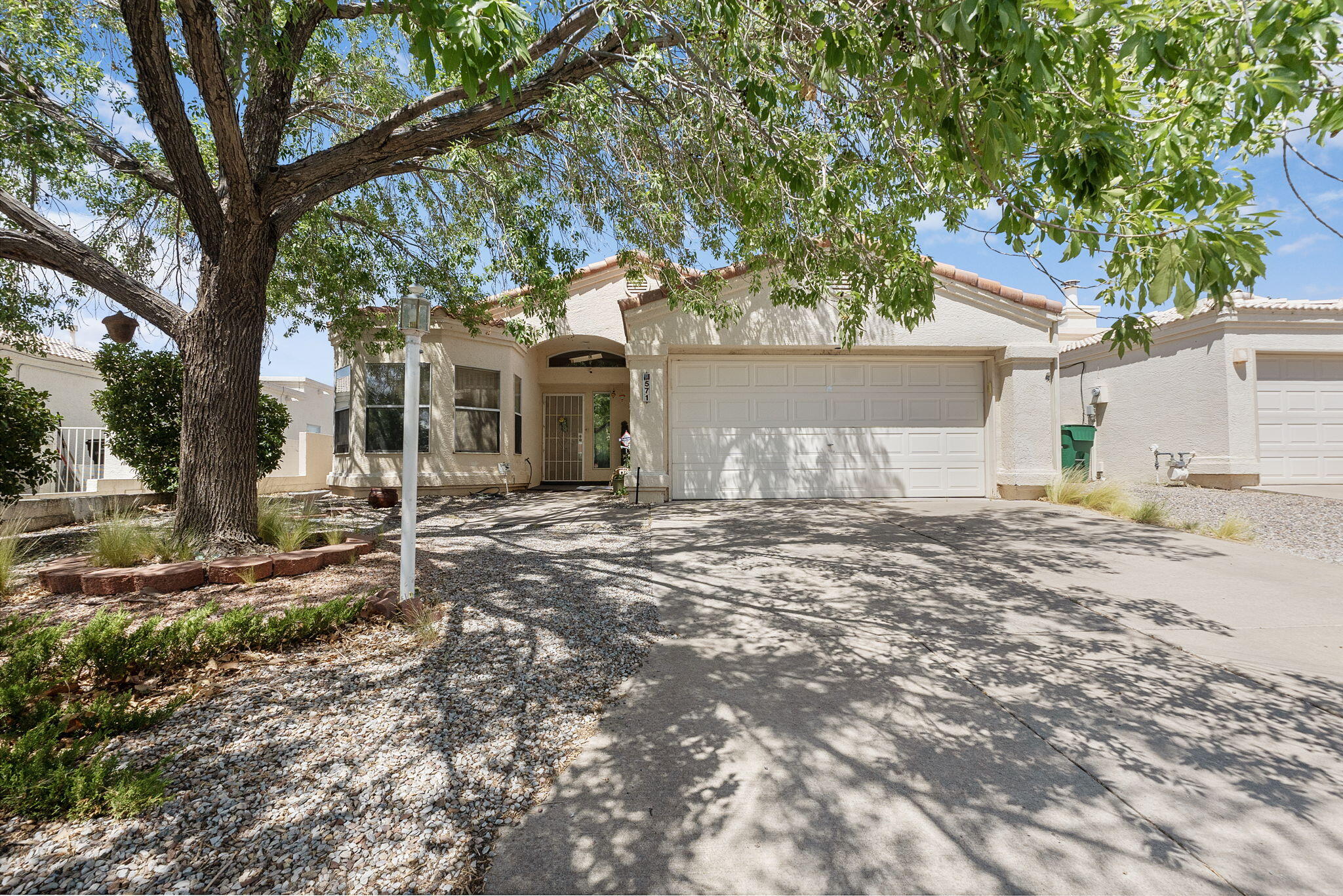 This home checks all the boxes! Great curb appeal, open floor plan, and a large bonus converted patio! (not included in sqft) Plenty of natural light throughout. The heart of the home is the expansive living room, centered around a cozy gas  fireplace that creates a warm, inviting atmosphere. Entertain with ease in the formal dining room. The primary suite is a true retreat, complete with a fireplace, a luxurious six-foot oval soaking tub, a separate shower, and a generous walk-in closet. Backyard has an additional covered patio. Spanish tile roof. Don't forget the amazing location! Rio Rancho is an award winning city for best quality of life overall. Rio Rancho School district.