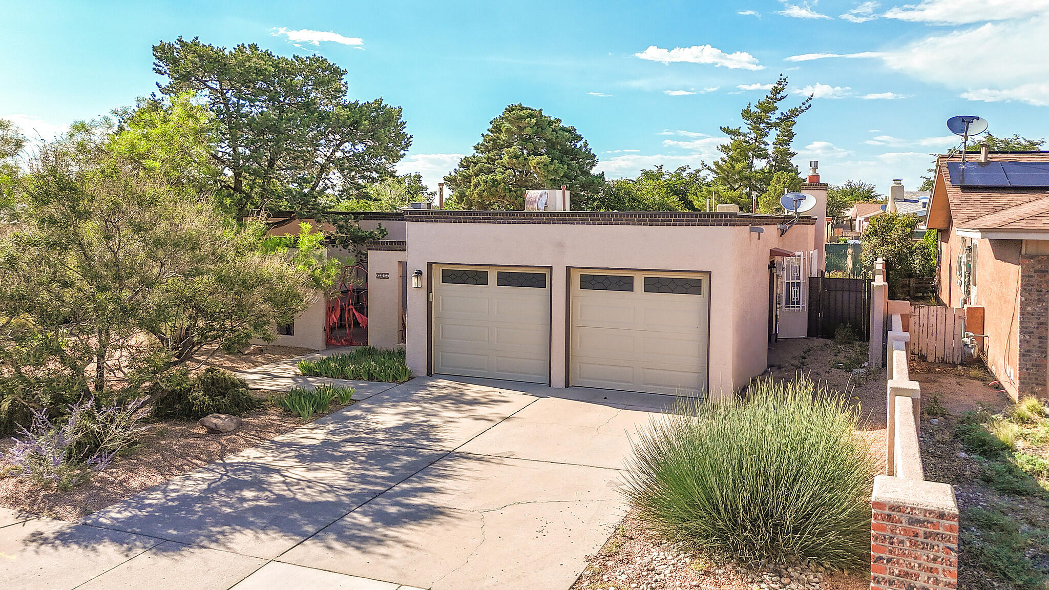 Public Remarks: Welcome to this charming NE Heights Home. The location cannot be beat and is close to the freeway, shopping, restaurants and grocery stores!! This 3-bed, 2-bath gem features an open living room with a natural gas fireplace. This beautifully remodeled kitchen is the perfect place to entertain. This home includes a breakfast nook, and a separate dining room that could double as an office or playroom.  The living room opens to a beautiful sunroom equipped with electricity, and lots of natural light! Step outside the sunroom to a beautifully landscaped well-maintained backyard with a Sandia Mountain view or step out front into the walled courtyard with raised flower beds, a custom gate and privacy. Enjoy a 2-car garage and extra storage throughout the entire home.