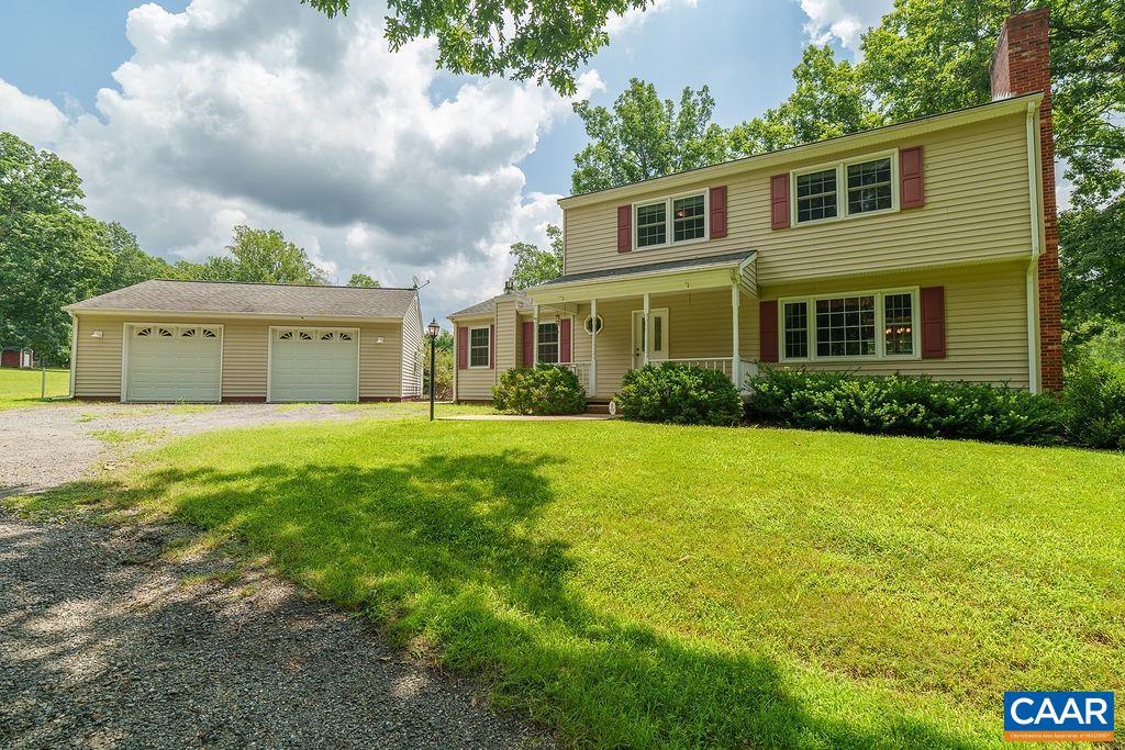 Nestled on 7.15 acres in N. Albemarle, this spacious and meticulously maintained home offers peace, privacy, and many practical amenities. The partially cleared lot features a pond, a two-bay garage with workshop, half bath, and attic storage, plus an additional two-bay garage and shed. There is plenty of space for a garden, animals or expansion. Inside, flexible living spaces including a formal living room, family room, and large year-round sunroom. Gather for casual meals in the eat-in kitchen or host elegant dinners in the formal dining room. Appliances are well maintained including a double-oven, plus artfully designed cabinet spaces and pantry. The walk-out basement features a rec room, half bath, and mechanical room with dog wash, washer/dryer, whole house vacuum, water filtration system, utility sink, refrigerator, freezer, and shelving. Upstairs, you’ll find four bedrooms and two full baths, and a convenient second level laundry. Multiple heating/cooling sources: heat pumps, mini-splits, baseboard radiators, and wood/gas stoves, offer comfort year-round. A whole house generator ensures peace of mind. Minutes from NGIC, Hollymead Town Center, and DIA. Property is also offered with an additional two acre building parcel.