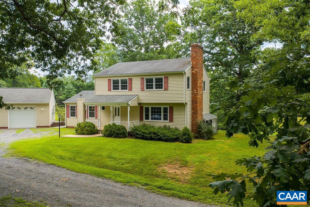 Nestled on 7.15 acres in N. Albemarle, this spacious and meticulously maintained home offers peace, privacy, and many practical amenities. The partially cleared lot features a pond, a two-bay garage with workshop, half bath, and attic storage, plus an additional two-bay garage and shed. There is plenty of space for a garden, animals or expansion. Inside, flexible living spaces including a formal living room, family room, and large year-round sunroom. Gather for casual meals in the eat-in kitchen or host elegant dinners in the formal dining room. Appliances are well maintained including a double-oven, plus artfully designed cabinet spaces and pantry. The walk-out basement features a rec room, half bath, and mechanical room with dog wash, washer/dryer, whole house vacuum, water filtration system, utility sink, refrigerator, freezer, and shelving. Upstairs, you’ll find four bedrooms and two full baths, and a convenient second level laundry. Multiple heating/cooling sources: heat pumps, mini-splits, baseboard radiators, and wood/gas stoves, offer comfort year-round. A whole house generator ensures peace of mind. Minutes from NGIC, Hollymead Town Center, and DIA. Property is also offered with an additional two acre building parcel.
