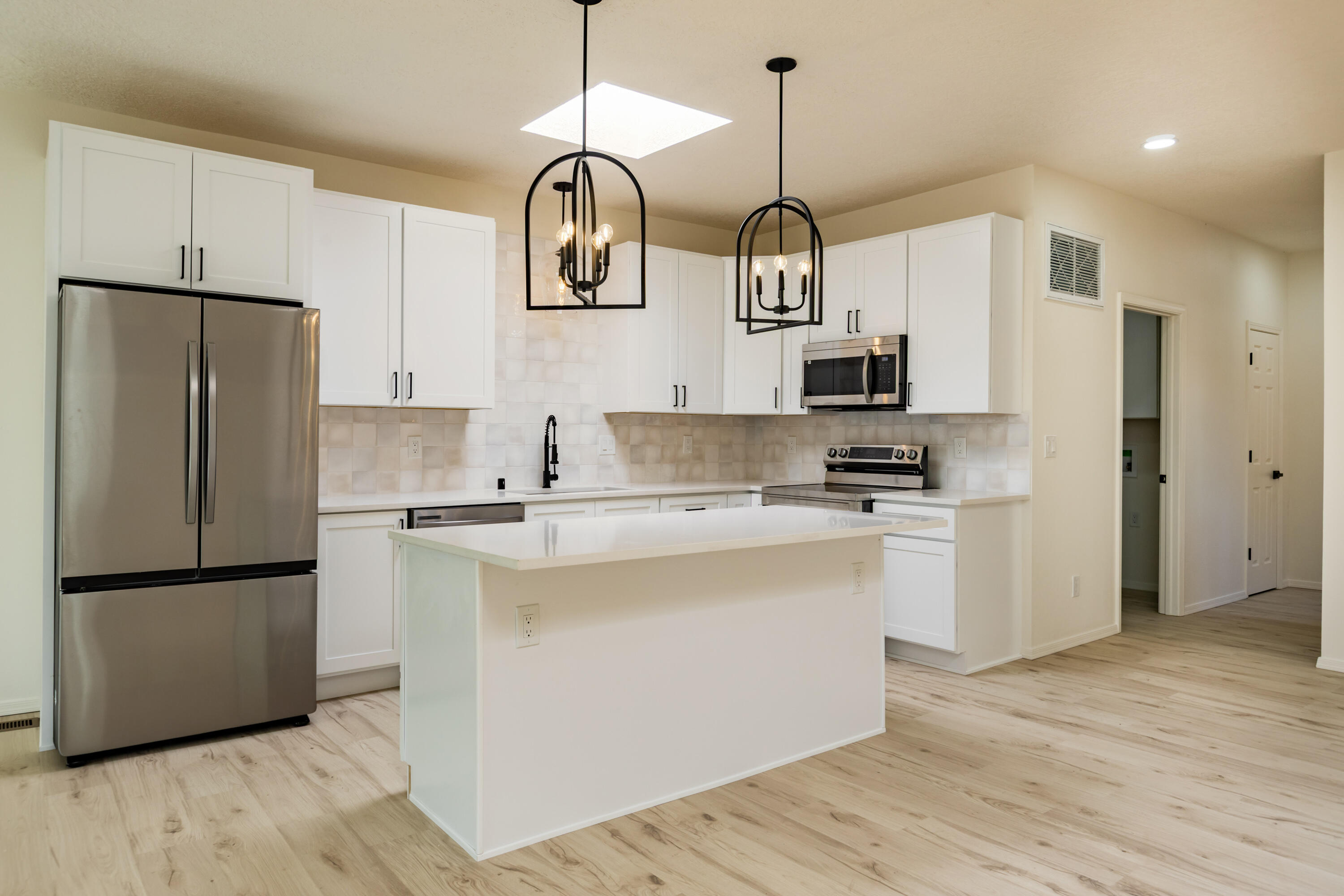 This home is basically New Construction. Everything is new. List of New items: TPO Roof, windows, stucco, HVAC, water heater, furnace, Refrigerated air, Doors, Garage door opener, electrical, Interior paint, flooring, bathrooms, kitchen, lights and appliances. Absolutely gorgeous remodel! 3BR, 3 Bathrooms, 2 car garage and yard space. Wonderful neighborhood. Turn key home.