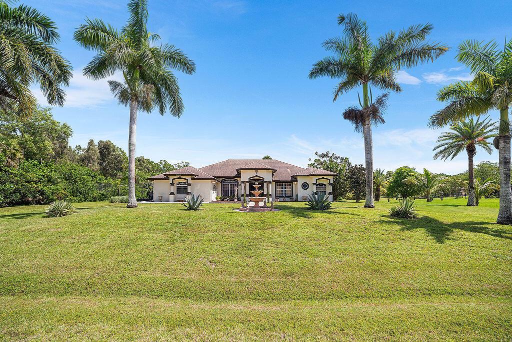 SELLERS ARE MOTIVATED! Welcome to this beautifully maintained 3-bedroom, 2.5-bathroom custom home with a versatile den/office, nestled on a spacious 1.14-acre lot in the heart of Loxahatchee. Built and lovingly cared for by the original owners, this property offers privacy, charm, and room to grow.Enjoy the serenity of mature fruit trees throughout the property -- a true Florida oasis. Inside, the home features a split layout, generous natural light, and thoughtful design perfect for both entertaining and everyday living.