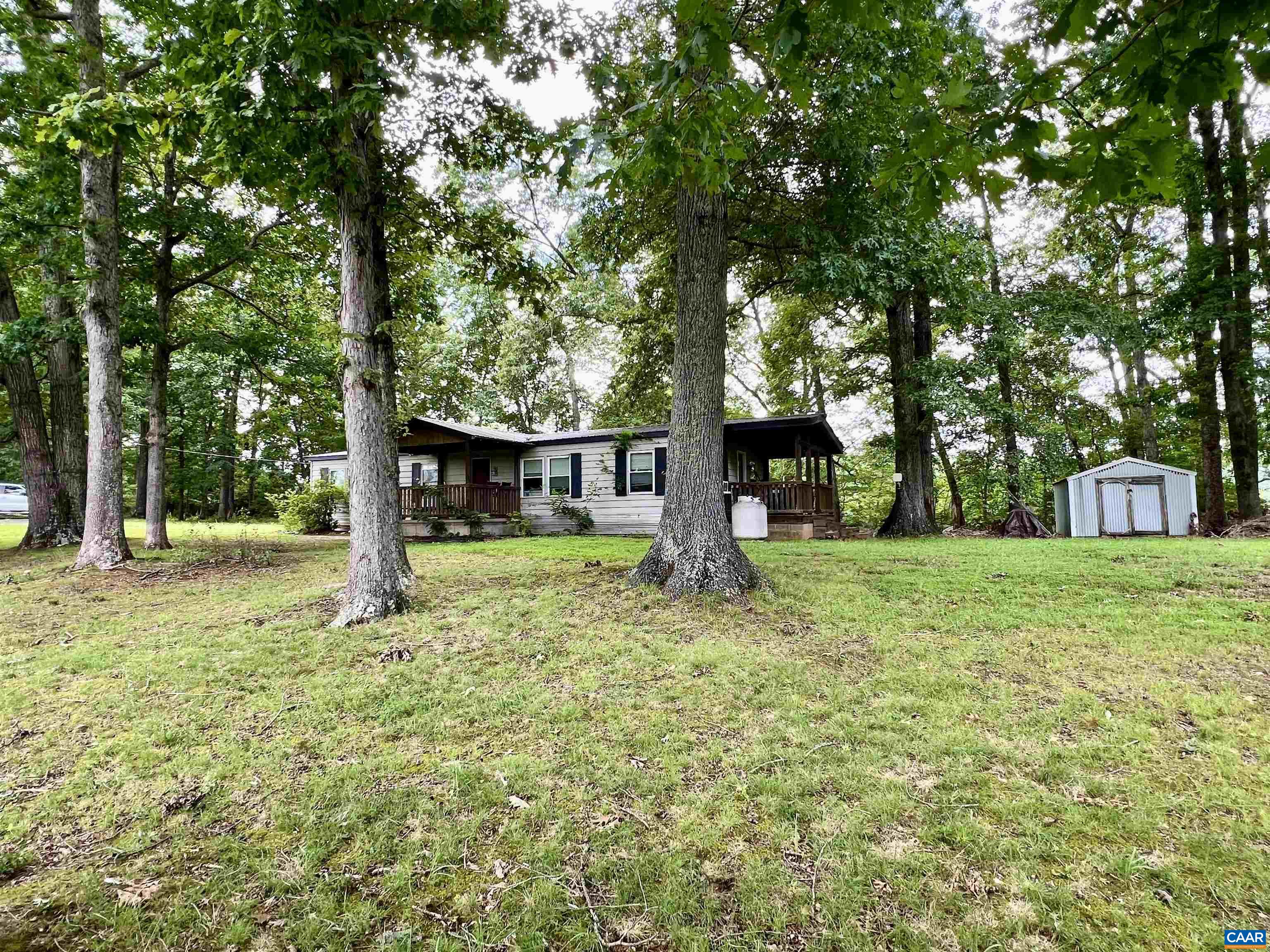Located in the desirable Western Albemarle District, this 2.29-acre property offers a fantastic opportunity to fix up the existing double-wide home or build new. The lot features an existing well and septic system, and has been recently perced—saving time and expense for future development.  The current home is a 3-bedroom, 2-bathroom double-wide with several outbuildings on the property. While it will likely not qualify for government financing, it’s an excellent candidate for a cash purchase or land loan.  Enjoy peaceful surroundings and scenic mountain views, along with the convenience of being in Albemarle County. A great investment for those looking for space, potential, and location.