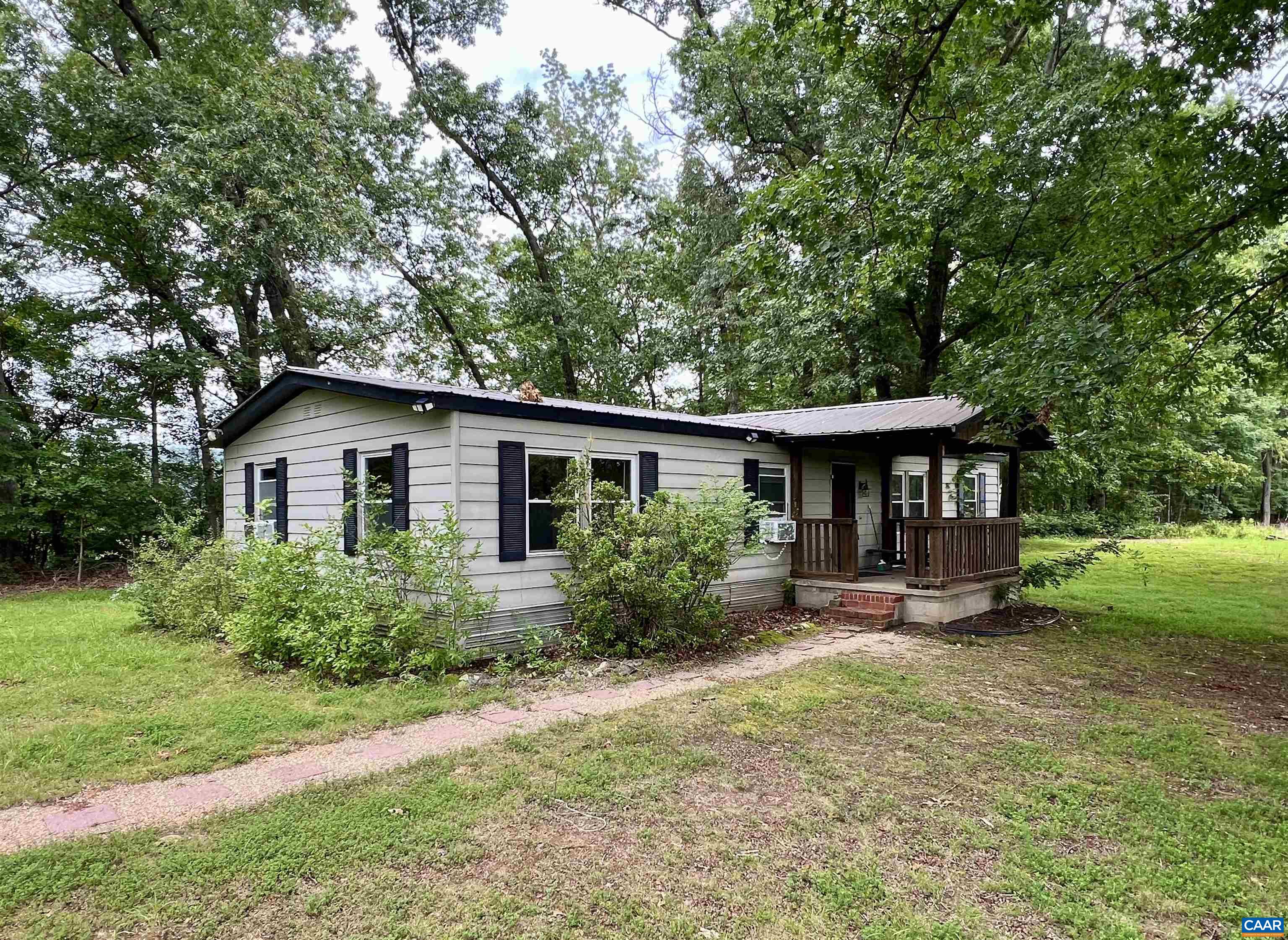 Located in the desirable Western Albemarle District, this  Batesville property 2.29-acre property offers a fantastic opportunity to fix up the existing double-wide home or build new. The lot features an existing well and septic system, and has been recently perced—saving time and expense for future development.  The current home is a 3-bedroom, 2-bathroom double-wide with several outbuildings on the property. While it will likely not qualify for government financing, it’s an excellent candidate for a cash purchase or land loan.  Enjoy peaceful surroundings and scenic mountain views, along with the convenience of being in Albemarle County. A great investment for those looking for space, potential, and location.