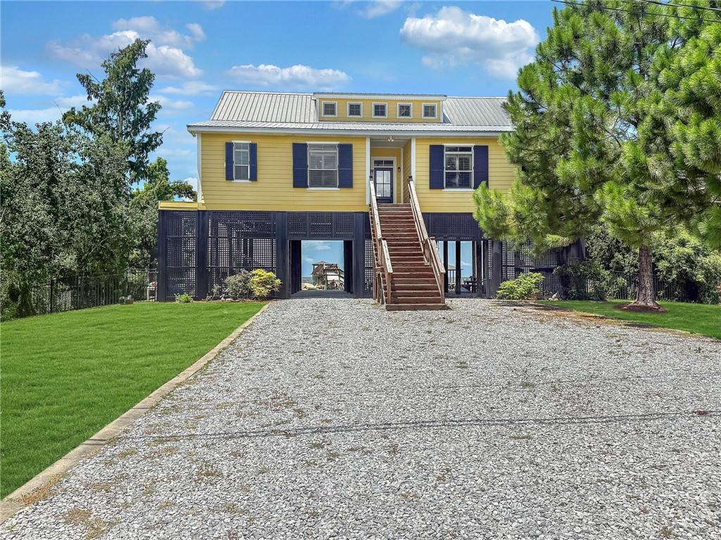 Live the Lake Life at Its Best!
Welcome to 419 Carr Drive – your front-row seat to sunrise coffees, sunset cocktails, and nonstop lake vibes! Nestled right on Lake Pontchartrain, this beauty serves up panoramic water views, including the New Orleans skyline (yes, really!).
The elevated design means tons of storage and parking below and an electric lift to load cargo and groceries, while upstairs you'll find soaring wood ceilings, an airy open floor plan, and a gourmet kitchen ready for everything from weekend brunches to crawfish boils.  The primary suite is pure relaxation with a spa-like bath featuring marble countertops.
Step out back to your own outdoor oasis - a huge porch for entertaining or soaking in the breeze. Love the water? You're covered with a boat house, lift, dock, and private pier - just bring the fishing poles and good times.
Whether it's your weekend getaway or your full-time happy place, this is lakefront living with serious style. Don’t miss your chance to own this slice of Louisiana paradise!
Agent related to seller.
