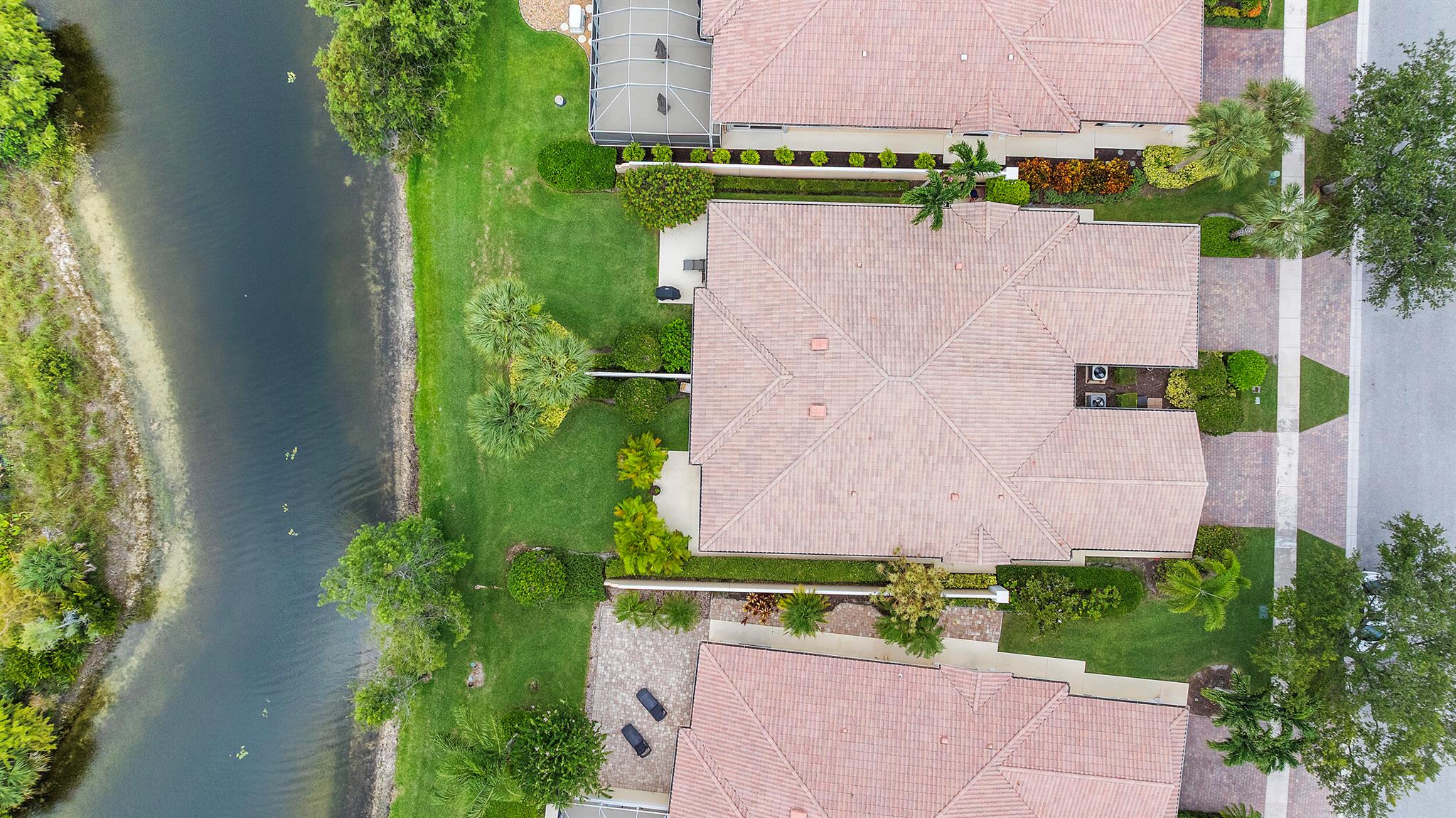 Beautiful Capri villa right on the preserve! This 2/2, split floor plan, with a two-car garage features total impact glass, updated kitchen, bathrooms and floors! BRAND-NEW A/C!! Plantation shutters on all of the windows! Central vac, separate laundry room with newer washer and dryer!  Screened-in patio AND a yard right on the water! New owners can lease right away, one time/year not less than four months. The amenities are endless!  Featuring a cafe, salon, post office, fitness center, dog groomer, library. Resort-style pool, separate lap pool, six tennis courts, pickleball, basketball, bocce, and scenic walking trails throughout the lakes and preserve! With 24-hour manned security, ALL AGES WELCOME!!!