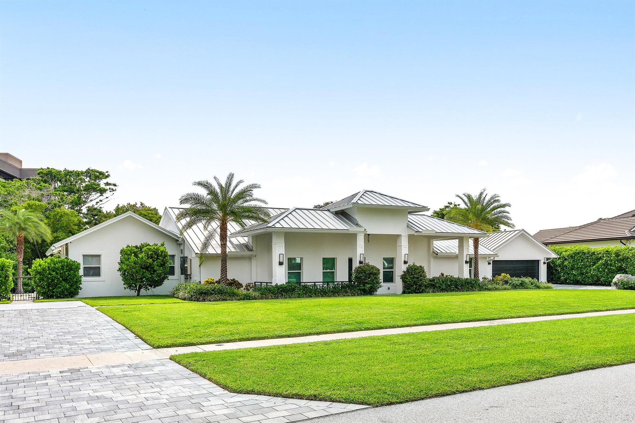 Whole house renovation and Master Bedroom addition in 2022, including new roof, AC units, electrical, plumbing. New trusses elevated ceilings to nearly 12 feet. Hidden Key is one of the most highly sought after communities, offering an ideal location, private gated entry, no HOA fees.  This immaculate estate provides the ideal Florida lifestyle with its sophisticated design and high end amenities, including; Miele appliances, custom solid wood cabinetry, and quartz surfaces.  Enjoy your spacious, private outdoor space with salt system automated pool, sun shelf, and 16 person spa, brand new outdoor kitchen and bar, and 146 feet of private canal and new synthetic dock for up to a 22 foot boat.  The home also offers a 2 bdrm guest house, a perfect in-law suite, or rooms for older children.