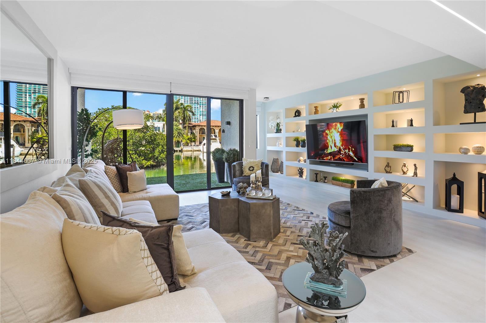 Probably one of the most astonishing townhouses on Poinciana Island.Waterfront remodeled 3bedr plus Office, 2.5bathr, 1car Garage + large driveway.Unique location close to beach (just across Collins Ave), shopping, restaurants, best schools.Ample windows & patio by waterway. Open kitchen: quartz tops/peninsula/backsplash, new SS appl.Living/Dining area: TVwall unit, light art & vaulted skylight, office overlooking.Top quality finishes: light fixtures, WallPapers, modern bathr, cabinetry, waterproof vinyl flooring, glass handrails,
garage opener w storage racks.Amenities: 4 lighted TennisCourts/2 pools/gym u renovation/1.5mi boardwalk.
Condo roof 2019, Boardwalk 2022. HOA $1,641/mo (incl Internet/Cable/Water). 
Furnishing&Deco for sale only $54,000
::Recorded video tour available::