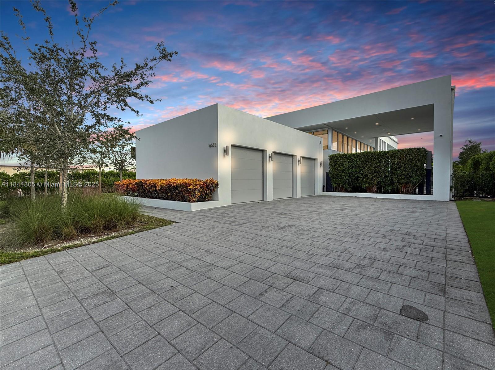 Live in luxury in this spectacular single-story residence located in the exclusive gated community of Botaniko Weston. Built in 2019, this property features 4 spacious bedrooms, 5.5 bathrooms, and a 3-car garage, all spread over 3,389 square feet of elegant and functional space. Its modern design offers high ceilings, abundant natural light, and top-of-the-line finishes. Enjoy an incredible backyard with a private pool, summer kitchen, and wet bar—perfect for entertaining family and friends. Sliding glass doors seamlessly connect the indoor and outdoor living areas. Botaniko Weston offers privacy, security, and an unbeatable location near top-rated schools, restaurants, shops, and golf courses. This is an opportunity you don’t want to miss!