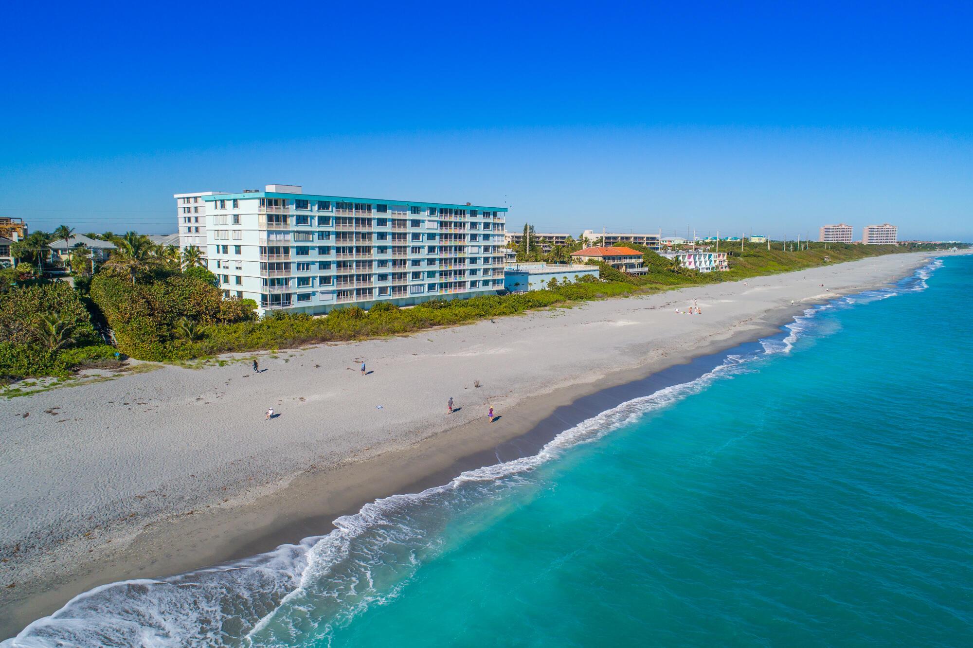 This beautifully renovated oceanfront condo at The Surf offers sweeping, unobstructed views of the Atlantic and an easy, turnkey lifestyle in the heart of Juno Beach. The entire unit has been thoughtfully redesigned with a clean, modern coastal feel. The open kitchen features sleek quartz countertops, European-style cabinetry, and a stylish backsplash that flows into the spacious living and dining areas--framed by floor-to-ceiling impact windows showcasing the ocean. Porcelain tile floors run throughout, and the primary suite offers its own incredible views along with a spa-like bathroom and custom walk-in closet. You'll also find a fully updated guest bath, new lighting and fixtures, impact glass windows and doors, and a full-size washer and dryer inside the unit. SEE MORE.. The oversized balcony is the perfect place to relax, unwind, and watch the sunrise and sunset.

The building just underwent renovations (seller has paid all assessments), with almost everything completed. Upgrades include concrete restoration, all-new balconies, waterproofed catwalks, rebar reinforcement, updated electrical systems, newly finished garages and pool, fresh exterior paint, and updated tropical landscaping. One of the standout features is the second-floor beachfront pool, which offers private beach access and elevated ocean views, making it feel like your own private resort. The Surf is a pet-friendly community with underground parking and an unbeatable location just minutes from the best dining, shopping, golf, and entertainment. This is a rare chance to enjoy luxurious, low-maintenance oceanfront living in one of South Florida's most charming beach towns.