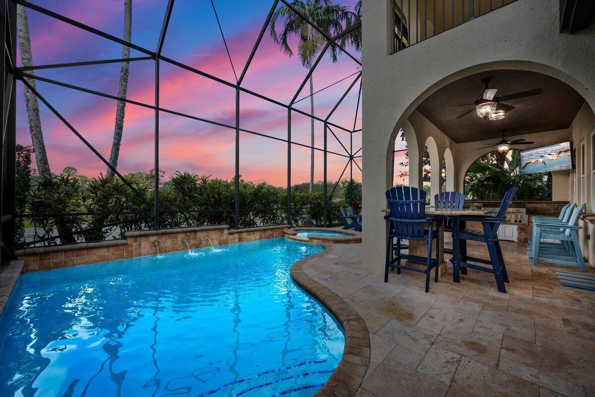 Presenting an exceptional opportunity to live your dream lifestyle in this beautiful two story, 3-bedroom, plus loft, 2.5-bath, lakefront, pool home in the highly desirable neighborhood of Evergrene. Perfectly situated on Bocce Court, this light and bright residence offers unparalleled attention-to-detail throughout, promising a living experience that is both luxurious and comfortable. For added peace of mind and energy efficiency, this home features Impact Windows and Doors throughout, plus a Whole House Generator. Step through the semi-circular foyer that truly sets the stage for this incredible home. The open chef's kitchen is a culinary dream, offering granite countertops, beautiful wood cabinetry, tumbled marble backsplash, stainless steel appliances, The spacious living area is complete with a large built-in entertainment center and French doors that open to an expansive two-story screened patio and custom outdoor kitchen, perfect for entertaining or simply relaxing after a beautiful day at the beach. Enjoy the flexibility of a separate formal dining room and separate living room, a spacious powder room, and a loft upstairs with extra storage ideal for a home office or gym. The primary suite offers a tranquil escape with its own private balcony, luxurious tub, dual sinks, large custom walk-in closet, and beautiful lake and pool views. The two additional light-filled and spacious bedrooms share an upgraded bathroom with solid wood cabinetry and a glass-enclosed tub/shower. Additional features diagonal tile floors on the main level, upgraded laminate flooring upstairs, plantation shutters throughout, ceiling fans throughout, upstairs laundry room with folding station, and a 2-car garage with tiled floors. Located in the prestigious guard-gated community of Evergrene, enjoy world-class amenities including a 20,000+ sq ft clubhouse, Tiki Bar, resort-style heated pool, fitness center, pickleball, basketball courts, splash park, and a full calendar of social activities. All just minutes from the beach, world-class dining, shopping, and top-rated schools in Palm Beach Gardens. Call now to schedule your private showing!