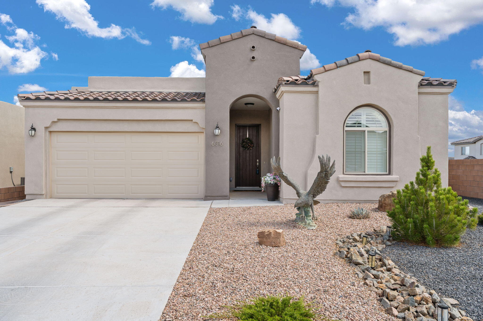 Sandia Mountain Views! This 2023 single-story stunner lives like a model home--it is immaculate and every upgrade has been done. Enjoy an open layout with 10'-11' vaulted ceilings, 8' doors, 3 bedrooms + office, and a premium corner lot with incredible Sandia views. The great room impresses with tile floors, wood beams, fireplace, and custom blinds/shutters. Chef's kitchen boasts quartz counters, oversized island, farmhouse sink, brick backsplash, built-ins, and a large pantry. Extras include a tankless water heater, water softener and reverse osmosis. Primary suite offers a tiled walk-in shower and huge closet. Backyard oasis with putting green, pavers, and elevated pergola. PID is paid--save thousands! Ask about a potential 5.75% rate!