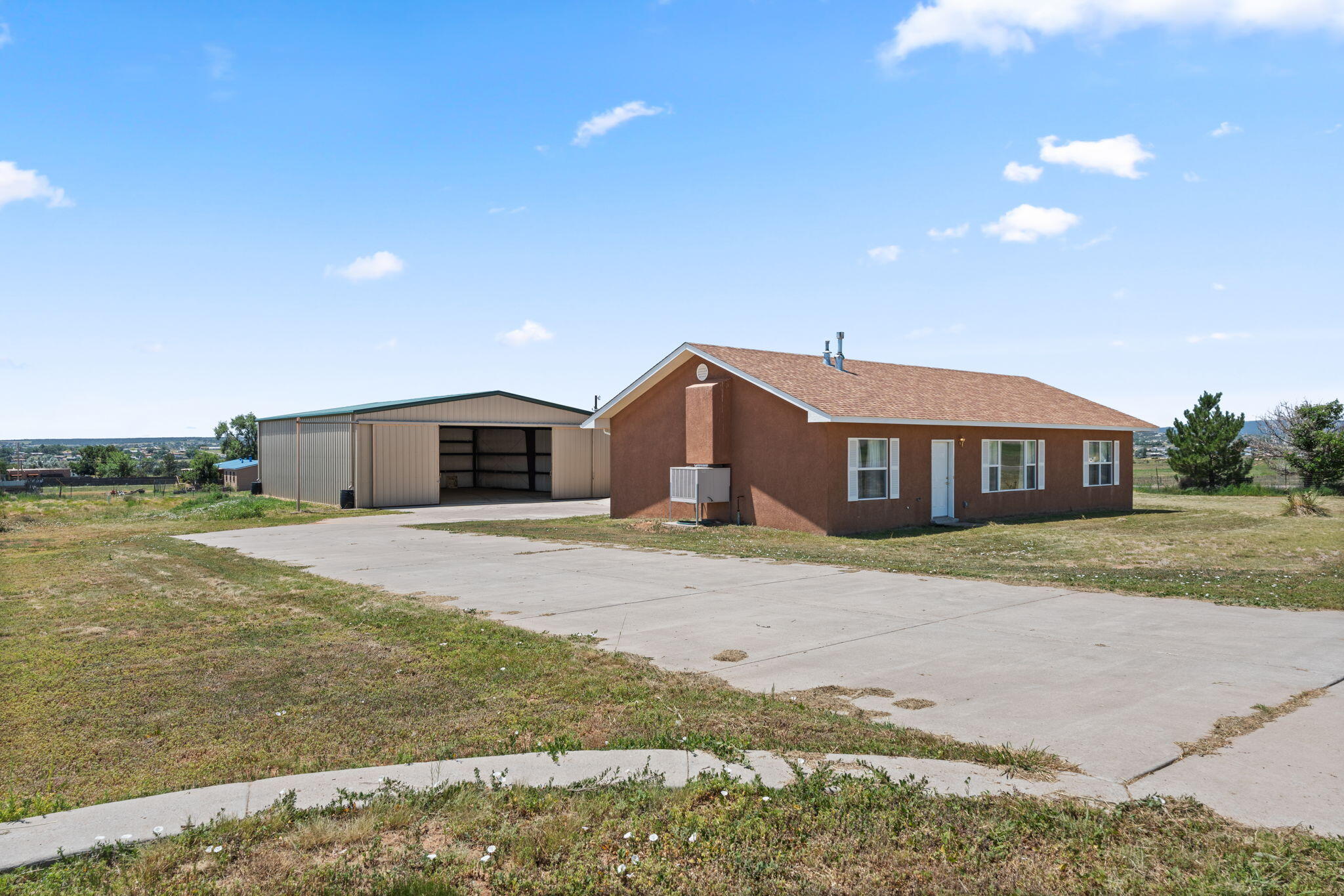 Literally the Sky's the Limit at this Amazing Property!! Located on a Fenced Corner Lot in the Sandia Airpark With 1.22 Acres. Live where you can Fly and Store your Planes. Plenty of Room To Garage Your Cars, RV's,Tools, and Equipment. Horses Welcome You Can Have it All. The home has a Light and Bright Open Floor Plan Cathedral Ceilings 3 bedrooms and 2 Bathrooms, The Primary Suite offers Double Sinks, Separate Shower, Garden Tub and Walk in Closet  Enjoy The Kitchen With Plenty of Counter Space and Breakfast Bar. A Spacious Great Room and Dining Room Combo For Those Family Get Togethers. Laminate and Stone Flooring Throughout. Control Your Home's Heating And Cooling With A Mini Split Cool/ Heat Combo & Central Heat & Evap Cooling. There are Two Hangars One Attached 36X44 Hangar/Garage