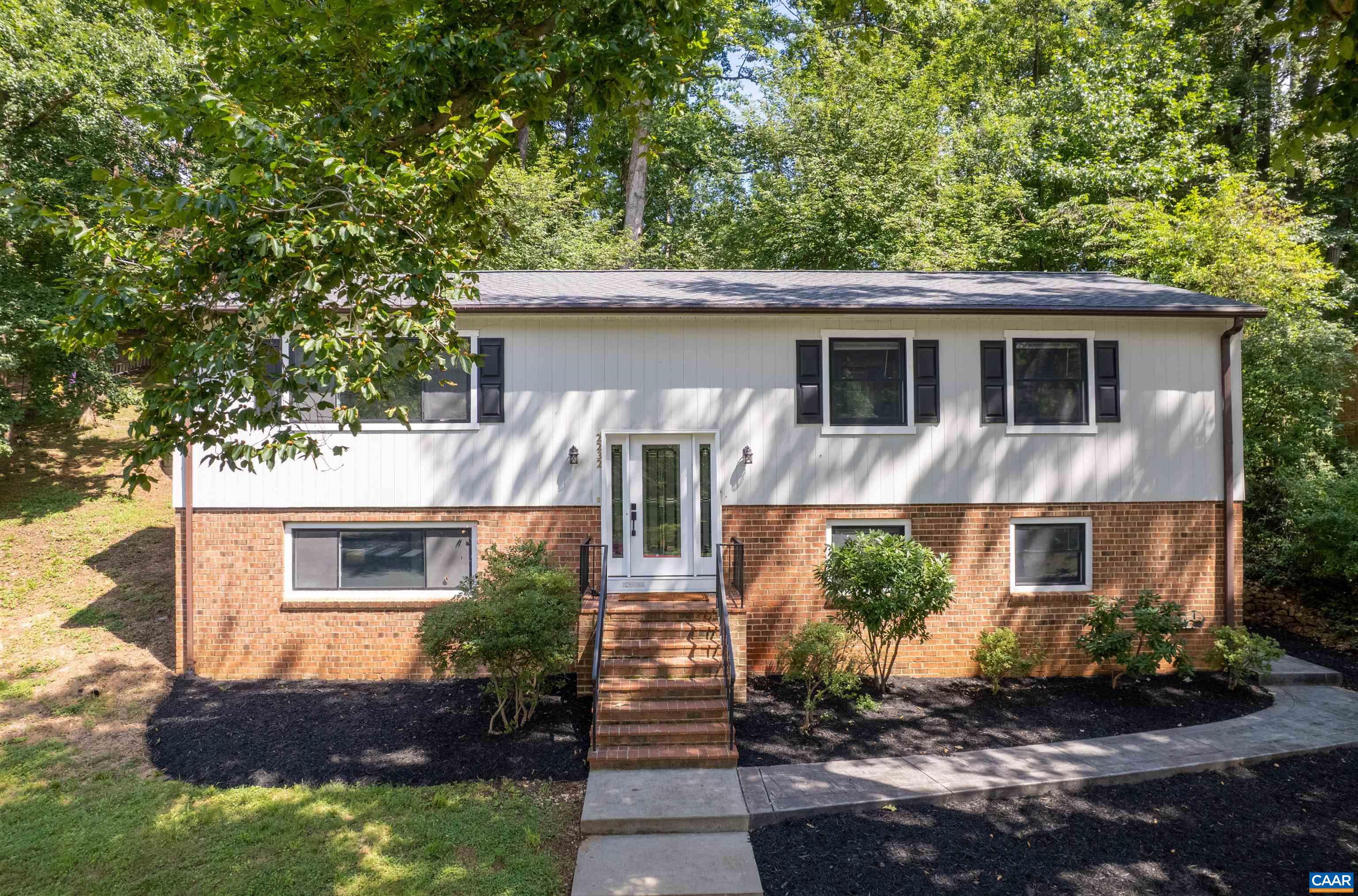 This home has it all – COMPLETELY RENOVATED!! NEW KITCHEN, NEW BATHROOMS, NEW FLOORING, NEW ROOF, NEW HVAC, NEW ANDERSEN WINDOWS!!! NEW PATIO!!! GREENBRIER SCHOOL DISTRICT!!! BEAUTIFUL, WIDE, TREE-LINED STREET!!! This 5-bedroom, 3-bath home features a warm and inviting layout with generous living spaces, hardwood floors, and plenty of natural light throughout. The main level boasts a family room with a fireplace, a casual dining area, a primary bedroom with ensuite bath, a second bedroom and NEW full bath, and a NEW kitchen. Downstairs, a spacious recreation room with a fireplace provides the perfect second family room, while the lower-level bedrooms and full bath are ideal for guests or a fantastic home office setup. Walk to Greenbrier Elementary, Rivanna River Trail, and Greenbrier Park. Take a look at this home and all it’s offering!