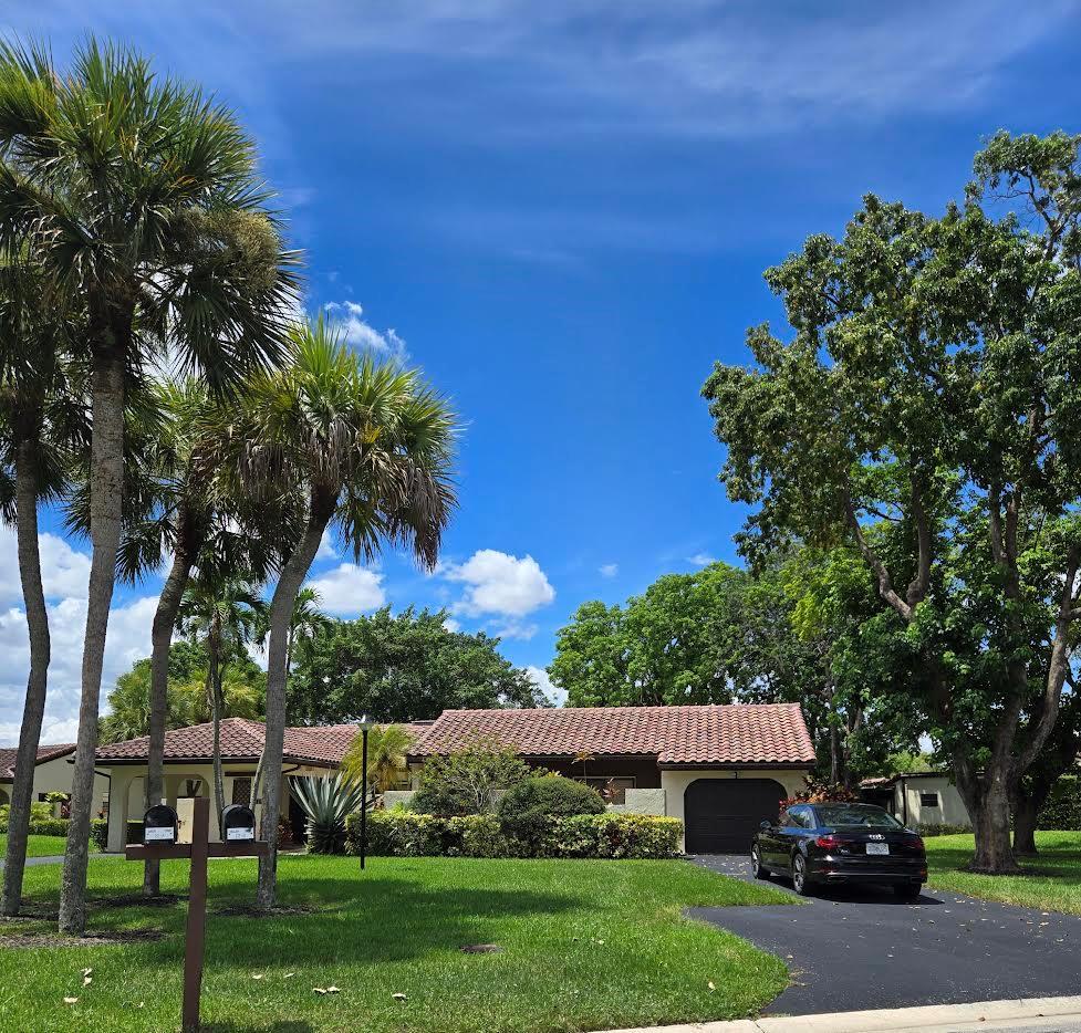 Elegant 3B/R 2 Bath villa. 2500 sq ft of living space. Lake view from a huge glass enclosed patio which can be used for office, 4th bedroom or entertainment space. This corner villa has extended driveway for several cars and a garage Villa is completely tiled with beautiful neutral tile and has been freshly painted and all new fans with remotes. New SS oven and microwave. All SS appliances and a wine cooler.  Lots of closet space. Front loading washer and dryer in a big laundry room. Non mandatory club. New roof installed 2023 and has been paid for. Newer AC and hot water heater, Lovely community pool. Guard gate entry.