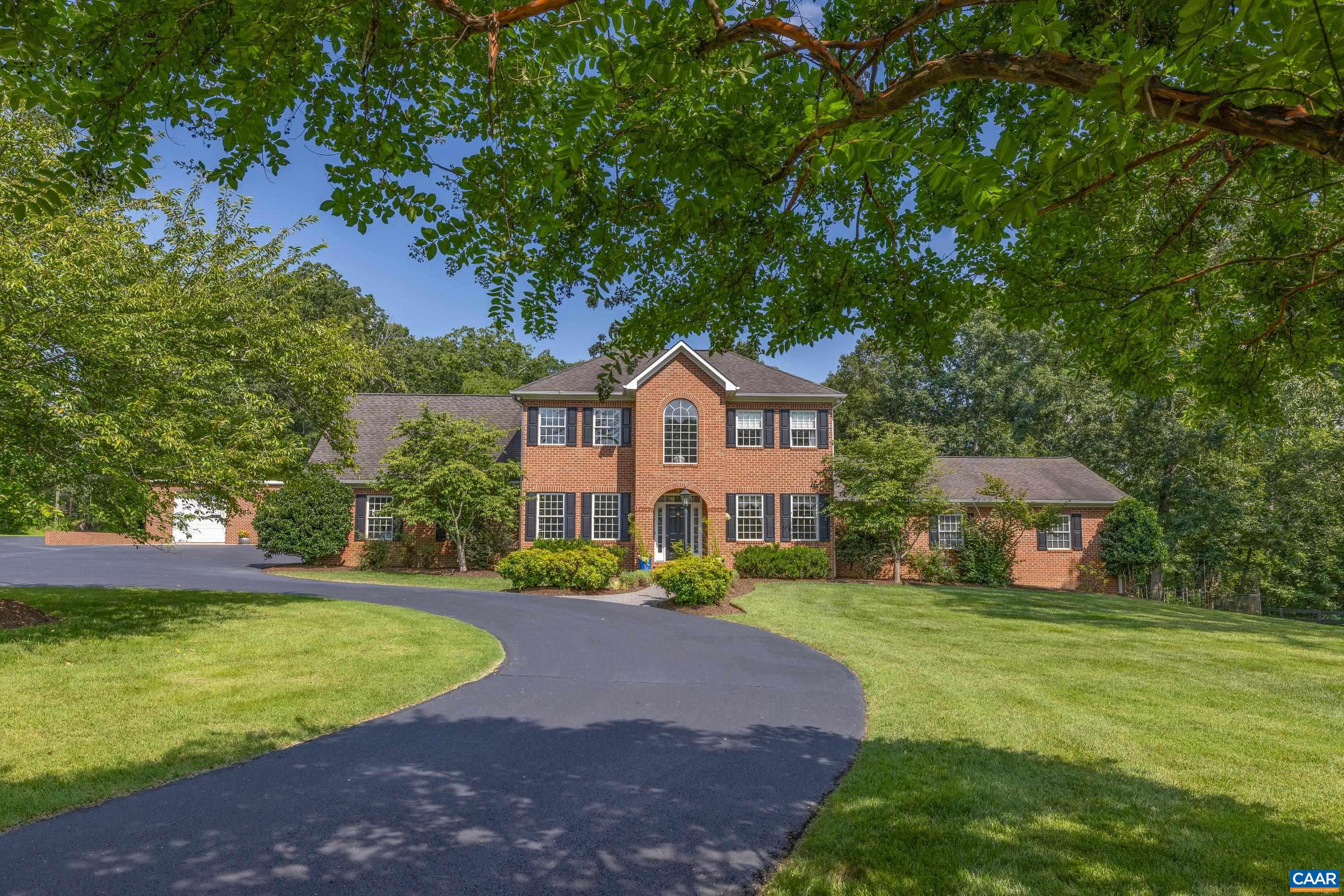 This rare Charlottesville retreat combines timeless original craftsmanship with a stunning 3,000 sq. ft. addition completed in 2001, offering incredible space and flexibility. Set on 2 private acres just minutes from the airport, Rivanna Station, the Innovation Corridor, and Hollymead Town Center, the location is unbeatable. Inside, you’ll find oversized bedrooms, a soaring great room with cathedral ceilings, a cozy fireplace, and a bright, modern kitchen perfect for entertaining. The versatile floorplan offers endless possibilities for a home office, study, library, media room, workout space, or private guest suite. Convenient first-floor bedroom options ensure accessibility for visitors or multigenerational living. The finished basement expands the living space further with room for hobbies, storage, or recreation. Step outside to your own private oasis—saltwater pool with hot tub, a pool house with bar, fire pit, and all pool furniture included for instant gatherings. Car enthusiasts or hobbyists will love the detached 3-bay garage/workshop with two car lifts, plus the attached 2-car garage. With amazing bones, endless storage, and room to relax or host, this home blends comfort, function, & an entertainer’s dream lifestyle.