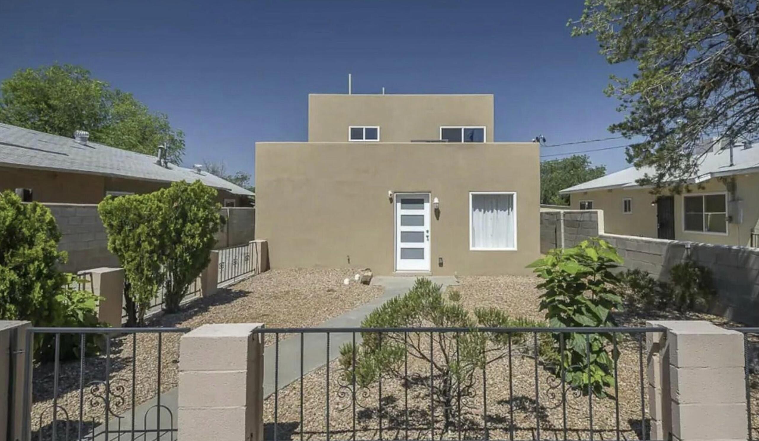 Welcome to this fully furnished 4 Bd, 2 BA gem, ideally located just minutes from ABQ's best restaurants, shops, world-class museums, and the ever-popular Sawmill District. Discover a spacious, light-filled layout with 2 generous living areas, a cozy dining nook, and a dedicated dining space. Upstairs, the private primary suite feels like a personal retreat with its expansive en-suite bathroom and versatile loft -- perfect for a home office, fitness area, or creative space.Recent updates include: energy-efficient vinyl windows, granite countertops, stainless steel appliances, updated bathrooms, a cozy wood-burning FP, and refrigerated air, 2-car carport adds both functionality and convenience. Turnkey short-term rental or a comfortable primary residence. This is it!