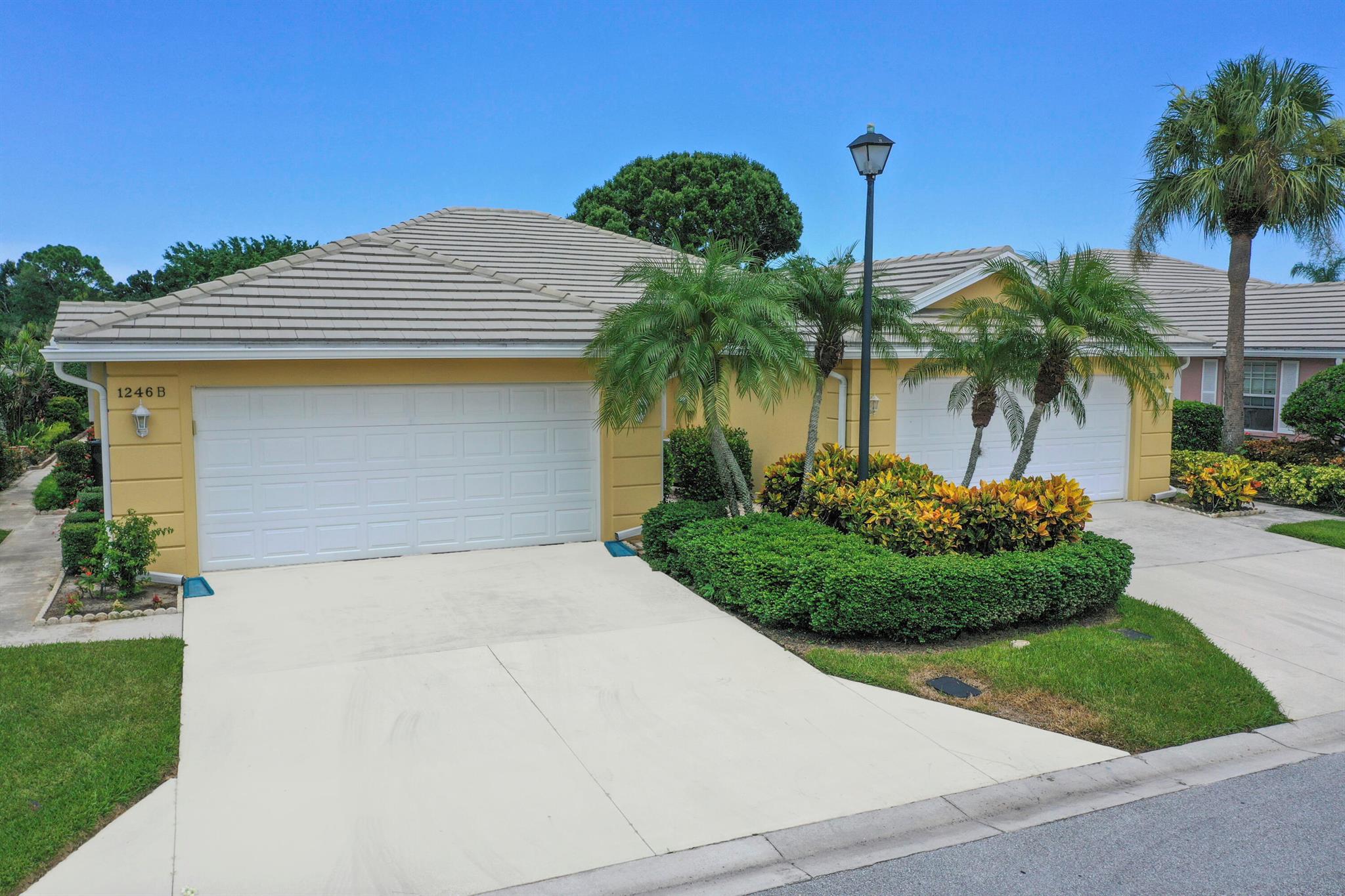 The location and view excel in this popular Lakes villa in St. Lucie West.  Both bedrooms are ensuite in this water view villa.  Ther is plenty of outside space to enjoy the Lake view with both a large, covered porch and open screened area.  This expanded Capri has extra room for an open den or Florida room.  The kitchen has granite and newer SS appliances.  There is crown molding and laminate or tile throughout.  The AC, WH and plumbing were replaced in 2021 and the roof in 2012.  The living area has a gorgeous built-in with mirrors, perfect for a big TV and extra storage.  The location within the convenient Lakes is very private and is lushly landscaped at the end of the street.  Enjoy the low HOA fee and hurricane shutters in a villa close to everything St. Lucie West has to offer.