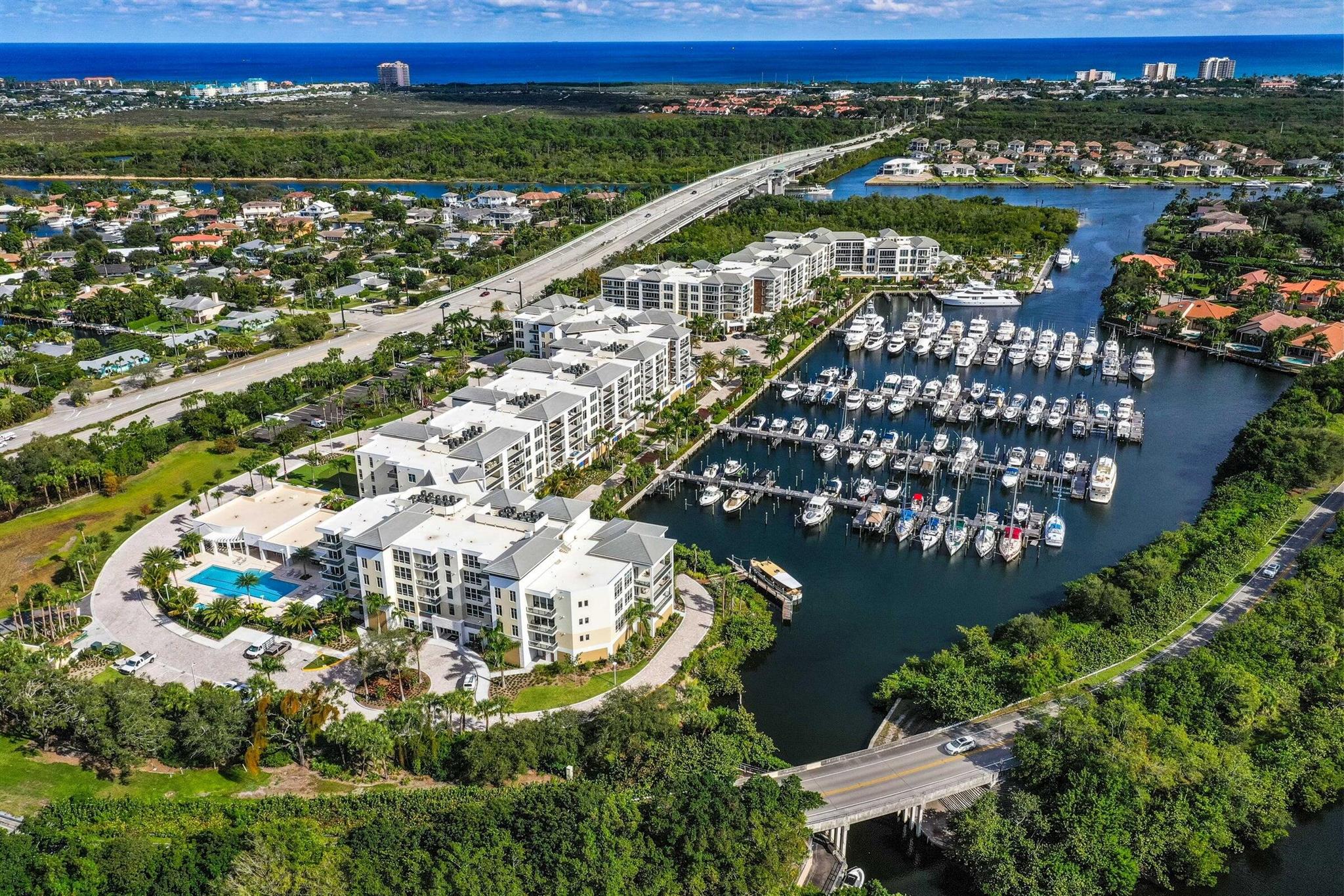 Welcome home to the exclusive community of Azure. Unit 203 offers endless room for entertaining on your extremely rare, nearly 3,000 sq foot patio with marina views. This is the ideal space to entertain both indoors and out. Large living area and one-of-a-kind designated bar promote comfort and enjoyment. Porcelain floors, custom built-ins, and high-end lighting. Step out of your private elevator into this spacious home with nearly 4,000 sq feet of living space. This efficient floorplan offers a large owner's suite, a secondary owner's suite and two additional, en-suite guest rooms. Located along the Intracoastal Waterway, this modern, gated community offers a marina, multiple pools. concierge service, fitness centers, golf simulator and putting green.Unit includes 3 garage spaces. Lutron lighting system, custom ceiling accents and lighting, porcelain tile flooring, his and hers master baths, and 10-foot ceilings are just some of the unique features of this unit that add value and enjoyment.