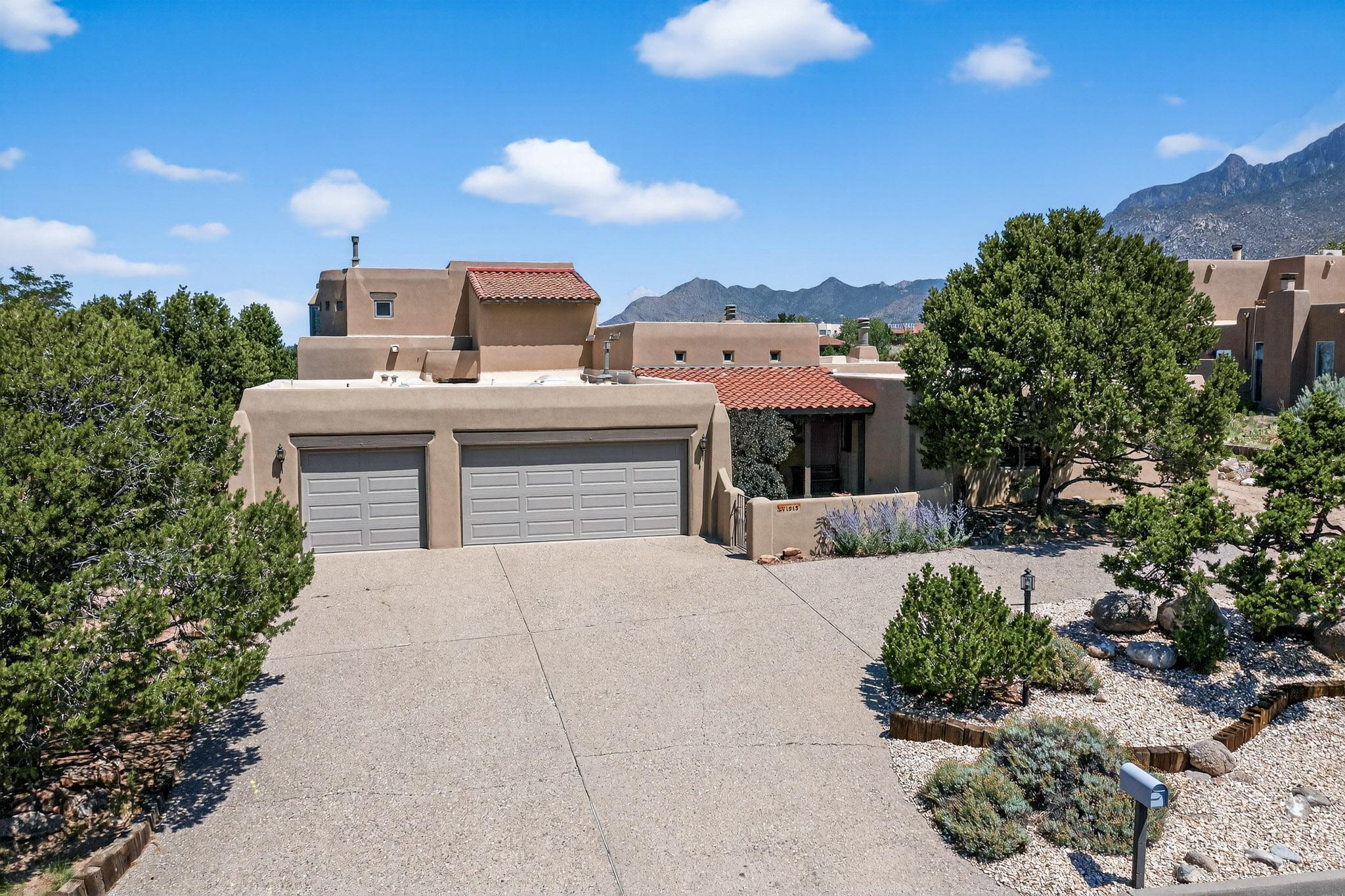 Welcome to this updated and well cared for single owner home on 1.2 acres in the luxury foothills neighborhood of Sandia Heights. Experience the expansive living areas, and distant views of the city, open space, and mountains. The SW style home features three fireplaces, two primary suites, a dedicated front office, a back office space that doubles as a 5th bedroom, and some ''accessibility'' features. The enormous walk-in closets and storage spaces will amaze you! A large covered back porch and shaded upstairs balcony connect you to the outdoors. Recent items replaced include a TPO roof, septic system, luxury vinyl flooring, appliances, countertops, undermount sinks, faucets, toilets, shutoff valves, shower valves, furnaces, hot water heaters, and garage doors. Don't let this one get awa