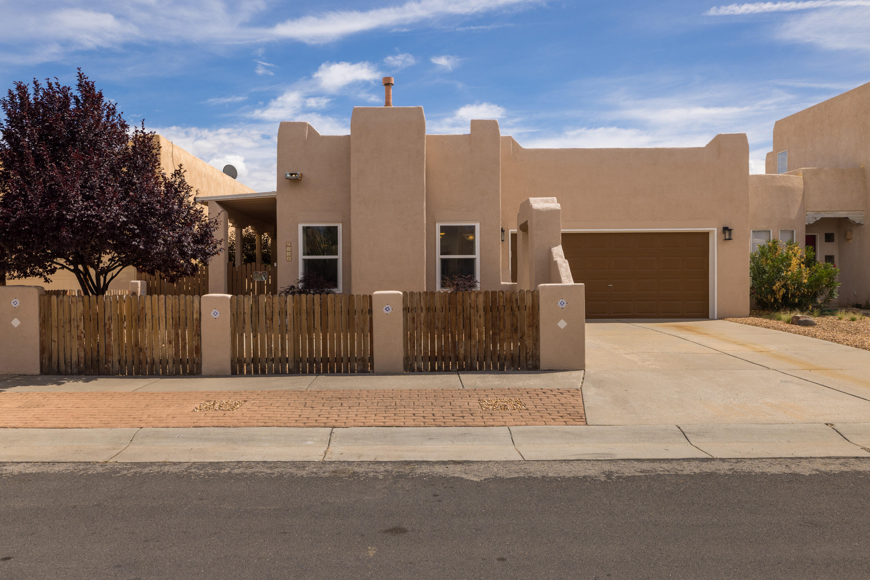 Southwest meets modern! Home features private courtyard entrance with covered porch. Raised wood beamed Tongue & Groove ceiling, tile floors, and Low-E thermal double-pane windows make for a bright open space. Living room, featuring gas log fireplace & is open to the dining room. Bright kitchen with SS appliances, white solid surface countertops, tile backsplash, & plenty of cabinet space. Bedrooms contain luxury vinyl flooring, solid wood doors, & 2 bedrooms have access to the back patio. The 3rd bedroom has 2 skylights. Primary bedroom features ensuite bath w/ granite counter tops, tile floors & shower/tub. Upgraded guest bath w/ modern vanity & tiled walk-in shower. Landscaped backyard w/ covered patio, trees & newer turf. Click ''MORE'' for additional information about the home.