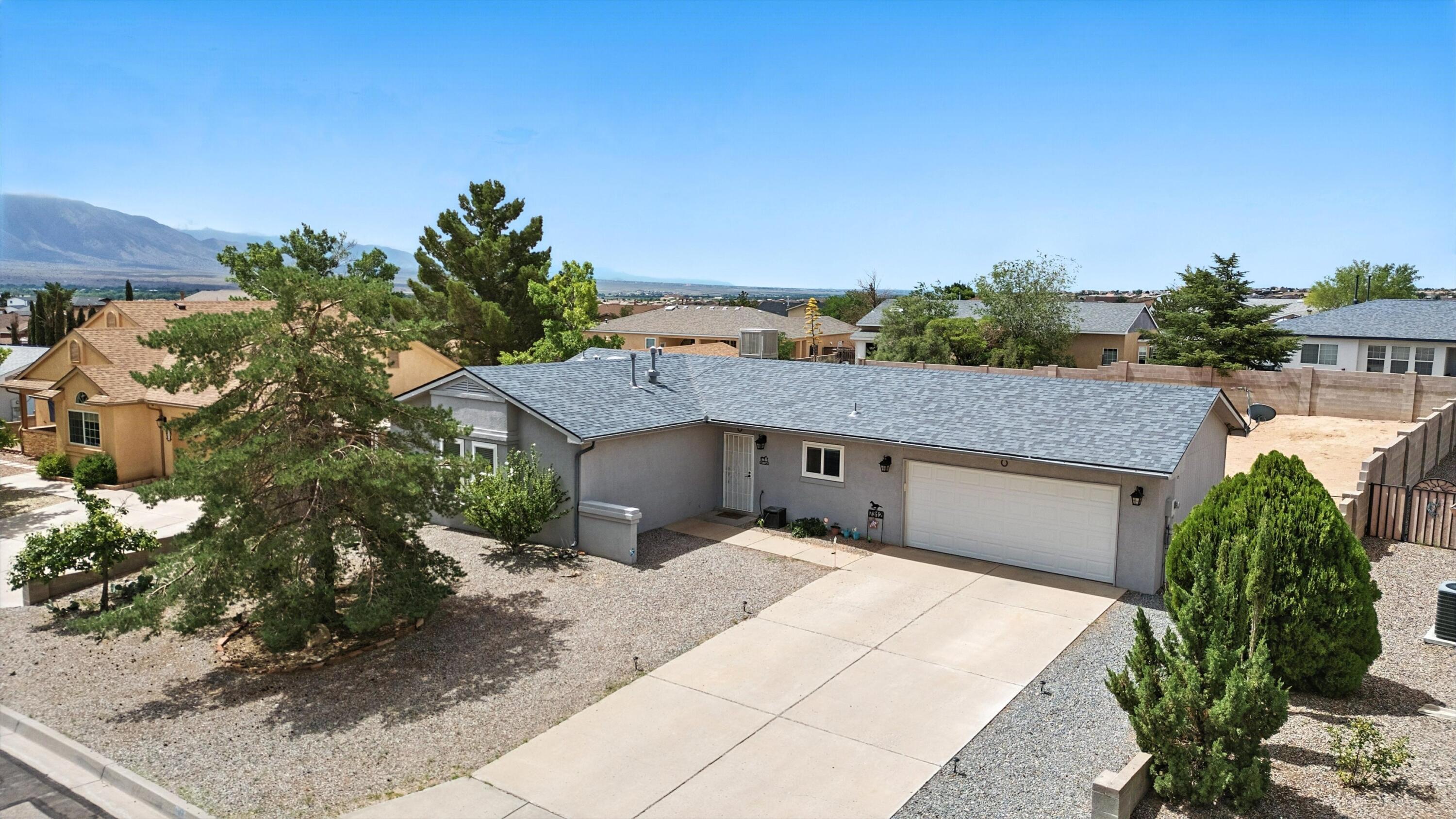 This sweet move-in ready home on more than 1/4 acre in desirable Enchanted Hills features an open floor plan that flows effortlessly into the fully enclosed backyard with access and views of the Sandias--ready for your dream garden, play space, or outdoor retreat. Enjoy relaxing evenings under the covered patio or take advantage of the generous yard's potential for expansion or entertaining. Recent updates include a newer roof (2021, under warranty), energy-efficient windows and sliding glass door (2020), and evaporative cooler (2024). Inside, you'll love the updated primary suite and guest bath. Attached 2-car garage, and classic stucco in front add plenty of curb appeal. Ideally located near main roads, great schools, parks, and shopping - this one's a must-see!