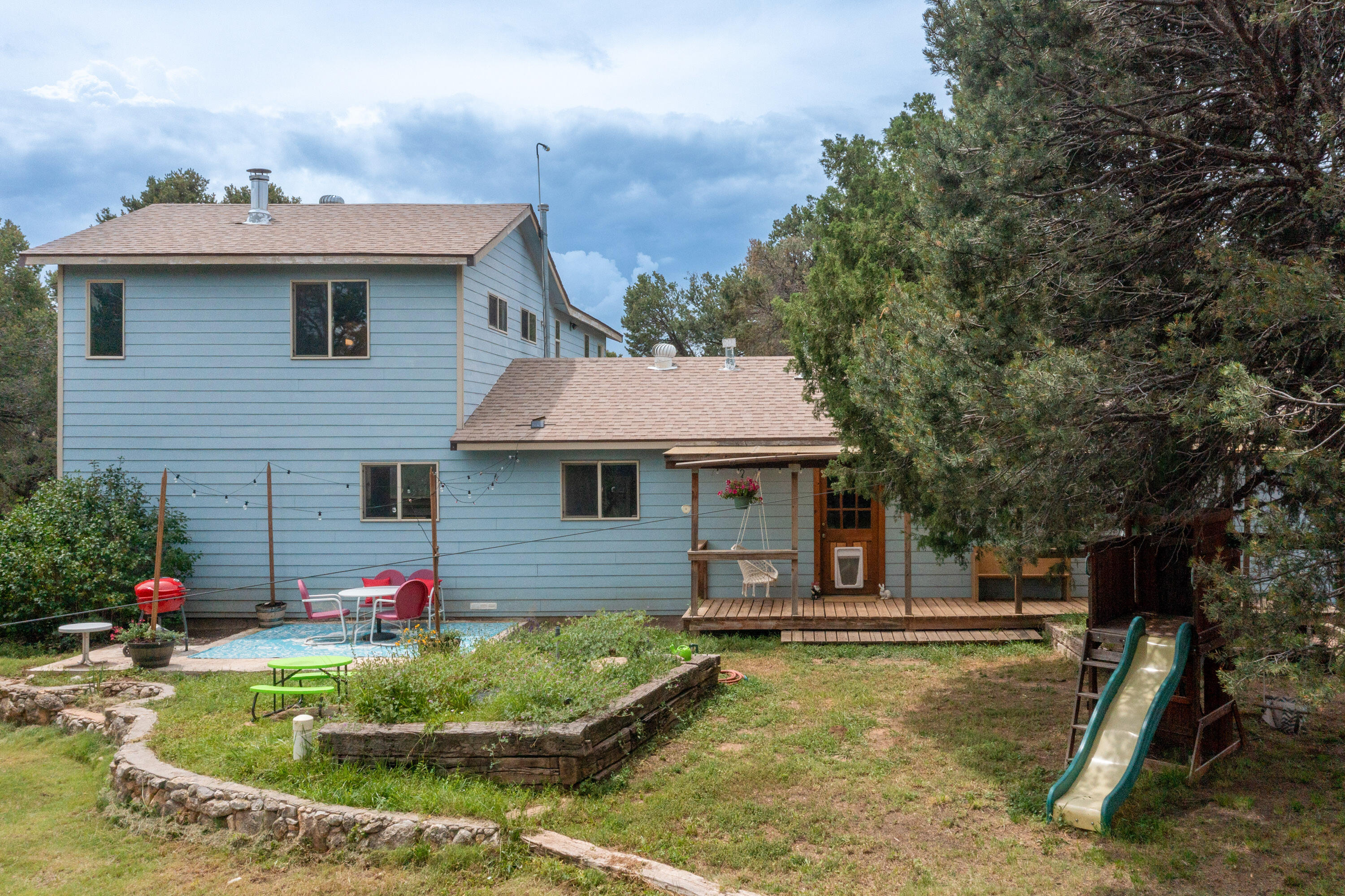 Leave the hustle and bustle of city life behind for a forested and serene escape. Close to Albuquerque and Edgewood for modern comforts and amenities, but far enough away to experience a true retreat, this home has it all: Horse stables, a corral, a large chicken coop, garden beds, a decorative pond, and even a zip line!Inside, you'll find high windows centered around a pellet stove to keep you comfortable in the winter, a wood stove in the dining area, newly installed mini split systems for on-demand refrigerated air conditioning and heating in the living room and all bedrooms.The bedrooms are delightful and just the right amount of moody, and the upstairs primary suite has tons of extra space. The downstairs bedrooms have newer flooring.You'll fall in love with this house!